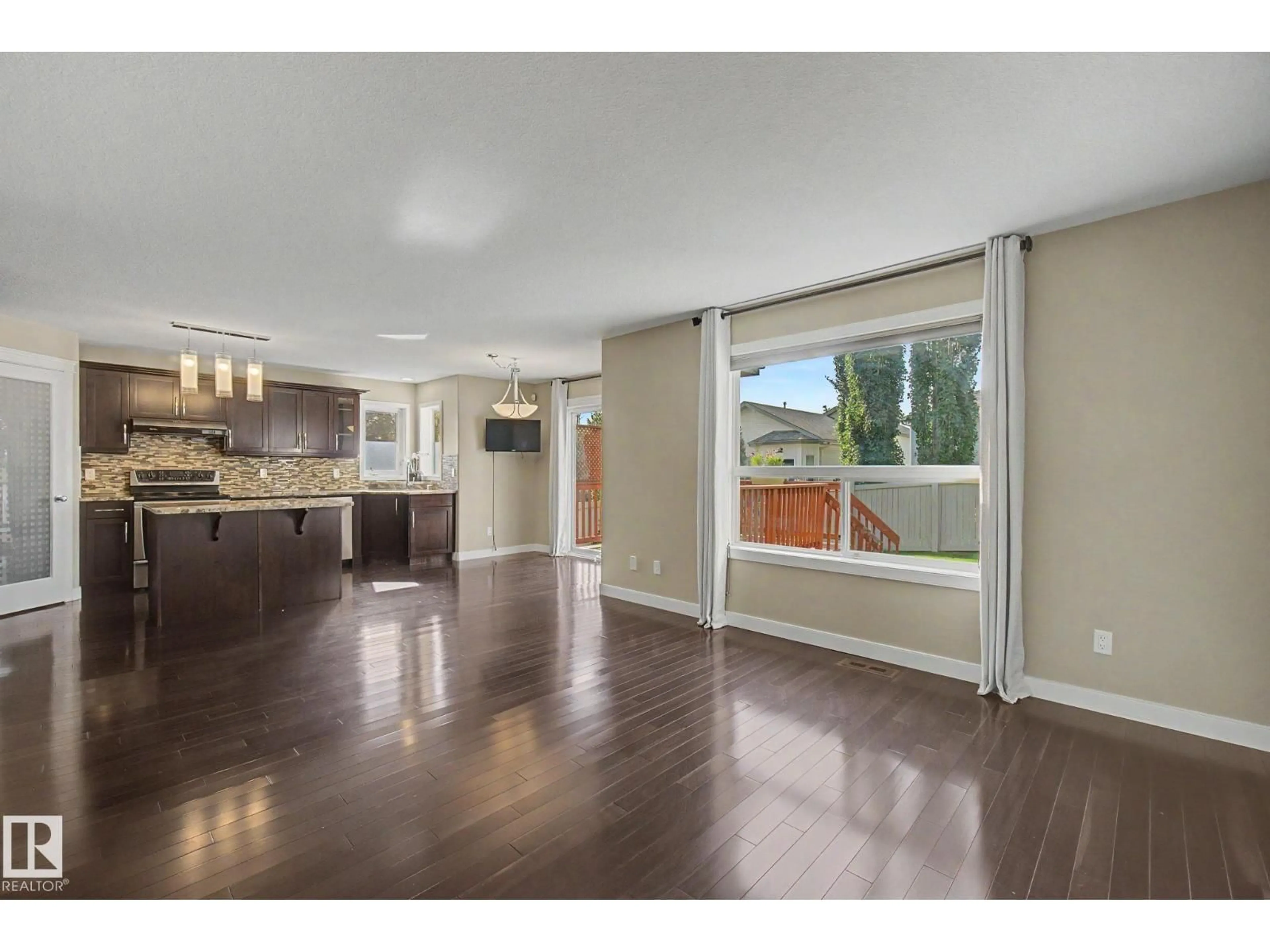 Open concept kitchen, wood/laminate floor for 1047 LEGER BV, Edmonton Alberta T6R3J9