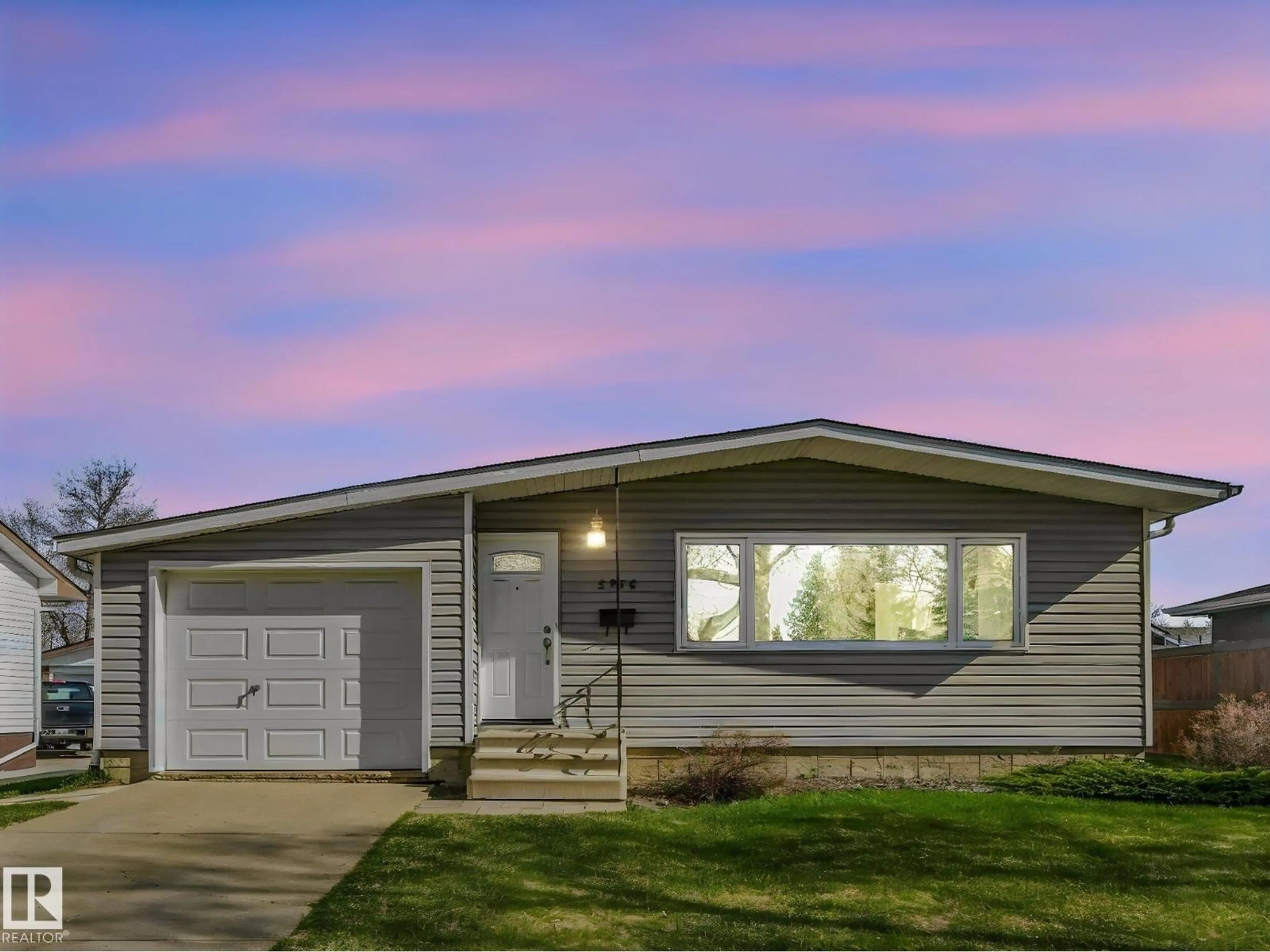 Home with vinyl exterior material, street for 5916 148 AV, Edmonton Alberta T5A1T9