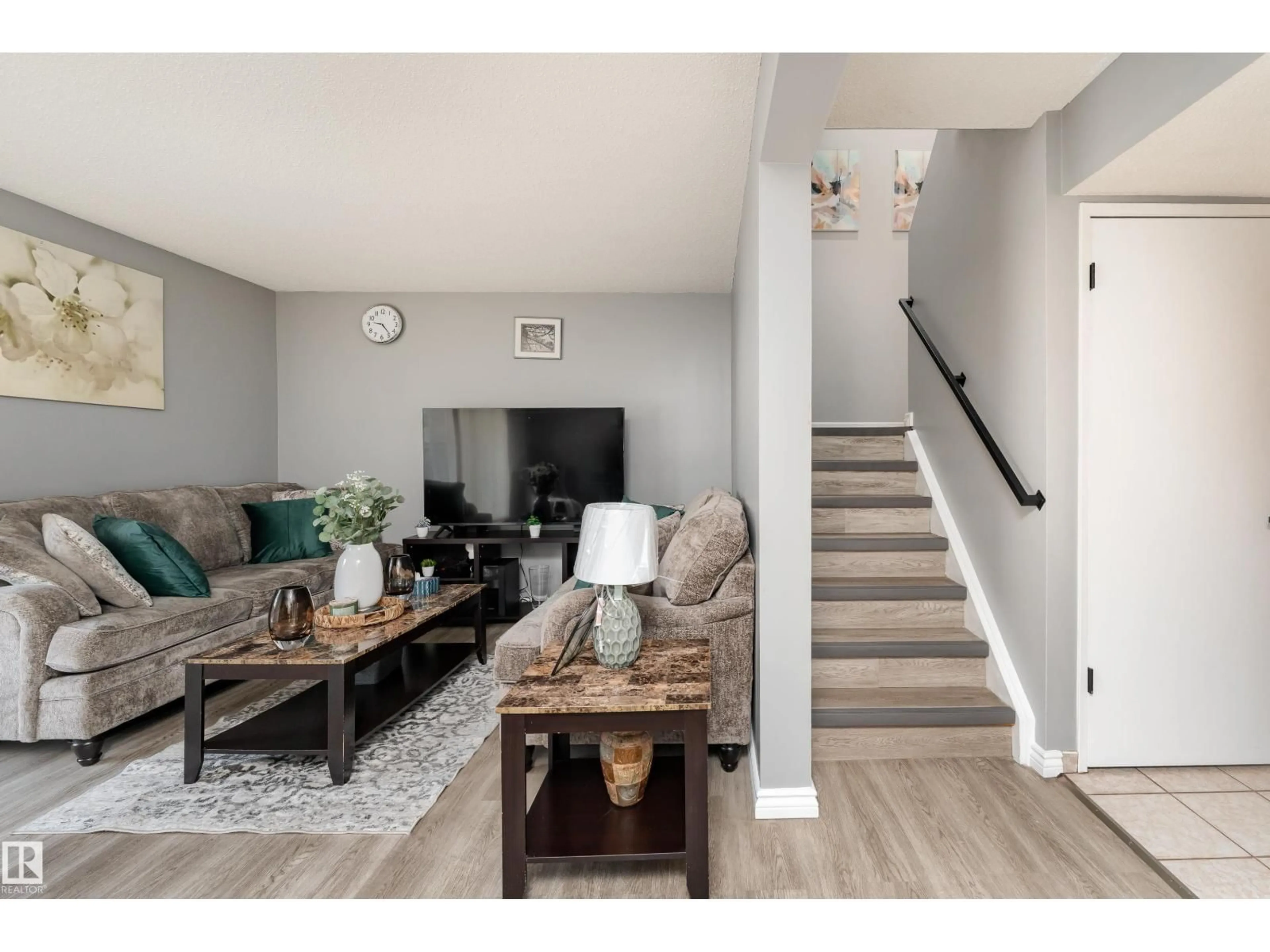 Living room with furniture, wood/laminate floor for NW - 6352 180 ST, Edmonton Alberta T5T2J6