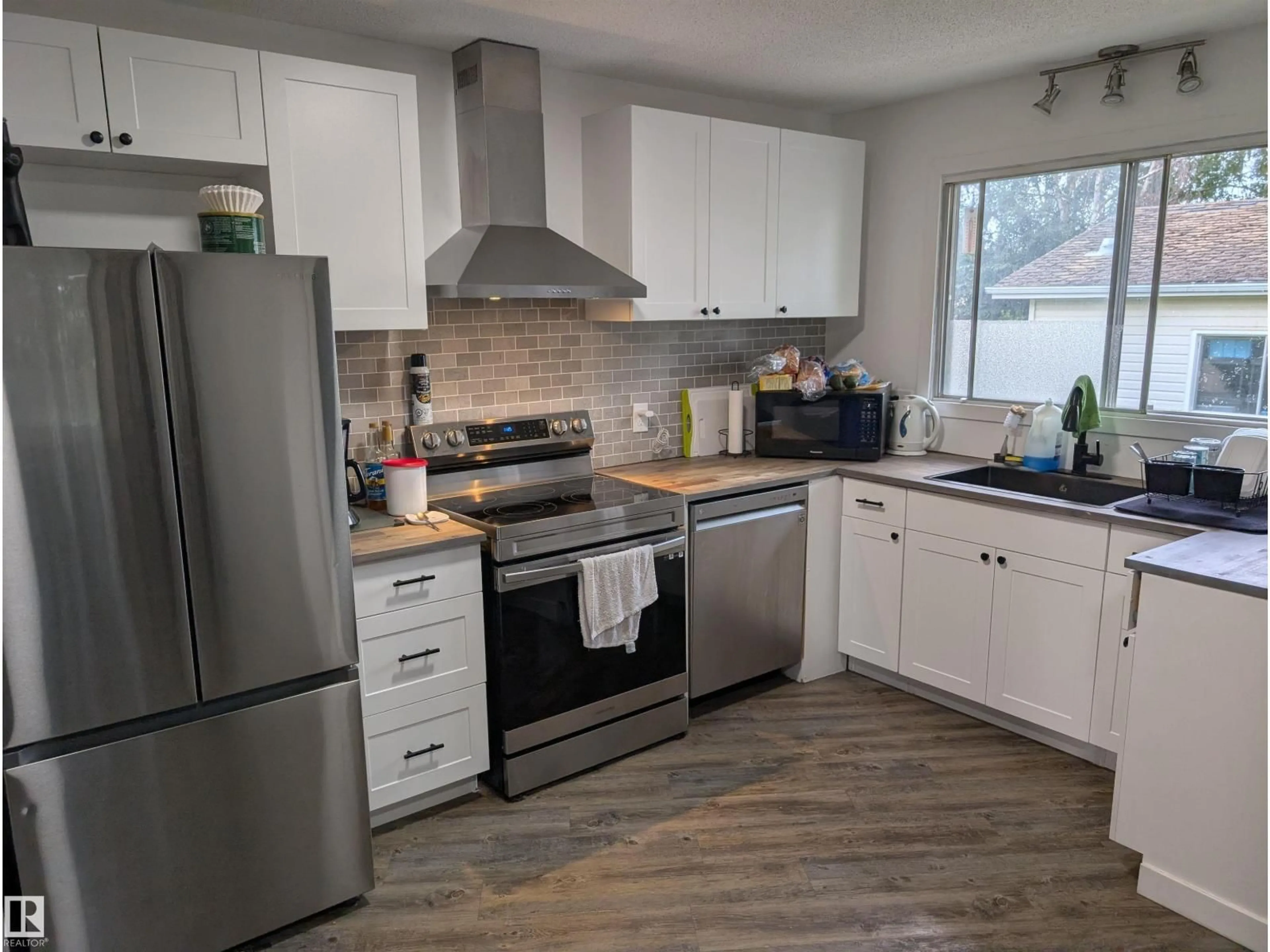 Open concept kitchen, wood/laminate floor for NW - 14228 22 ST, Edmonton Alberta T5Y1E5