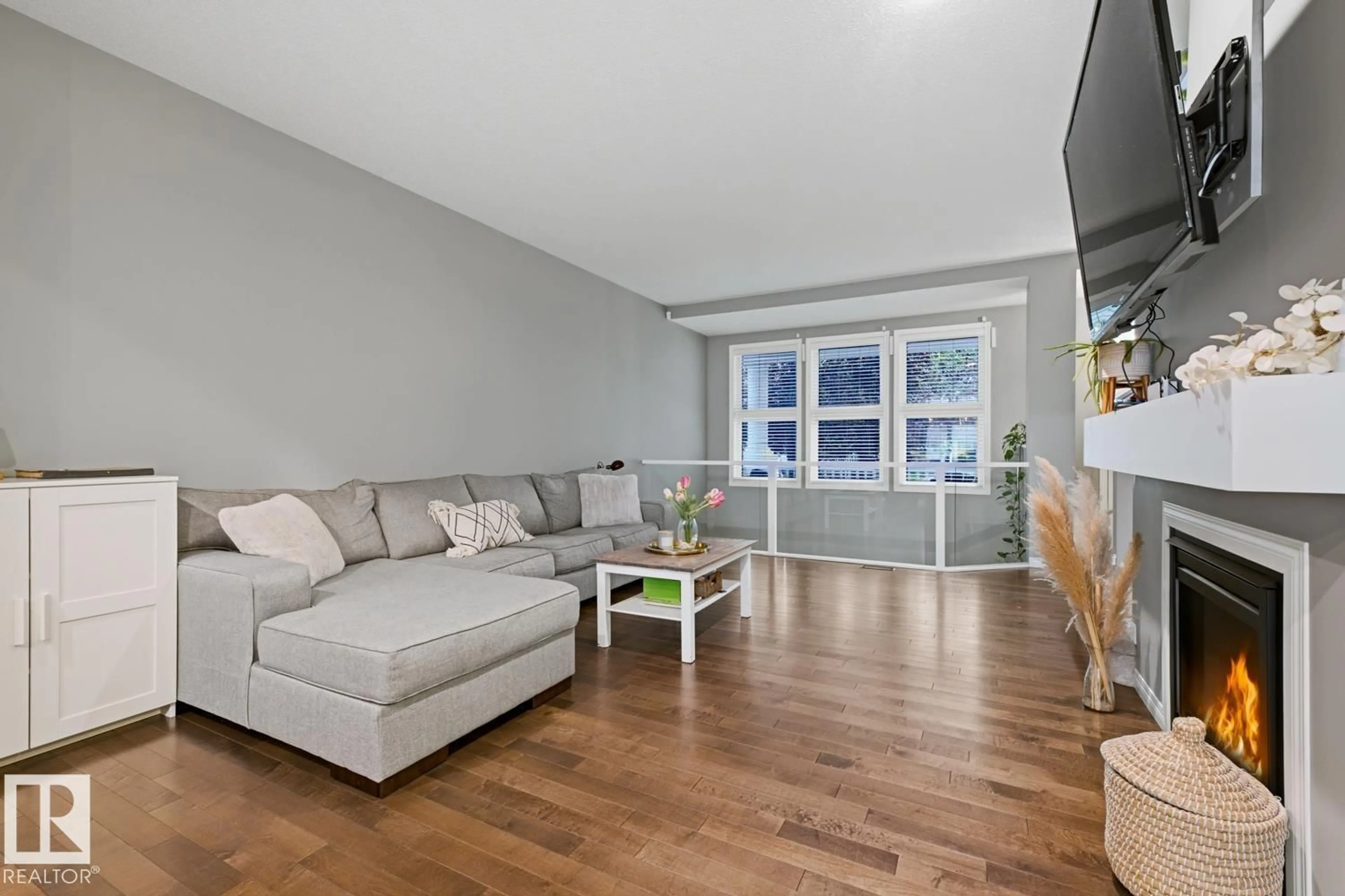 Living room with furniture, wood/laminate floor for SW - 2015 74 ST, Edmonton Alberta T6X0V7