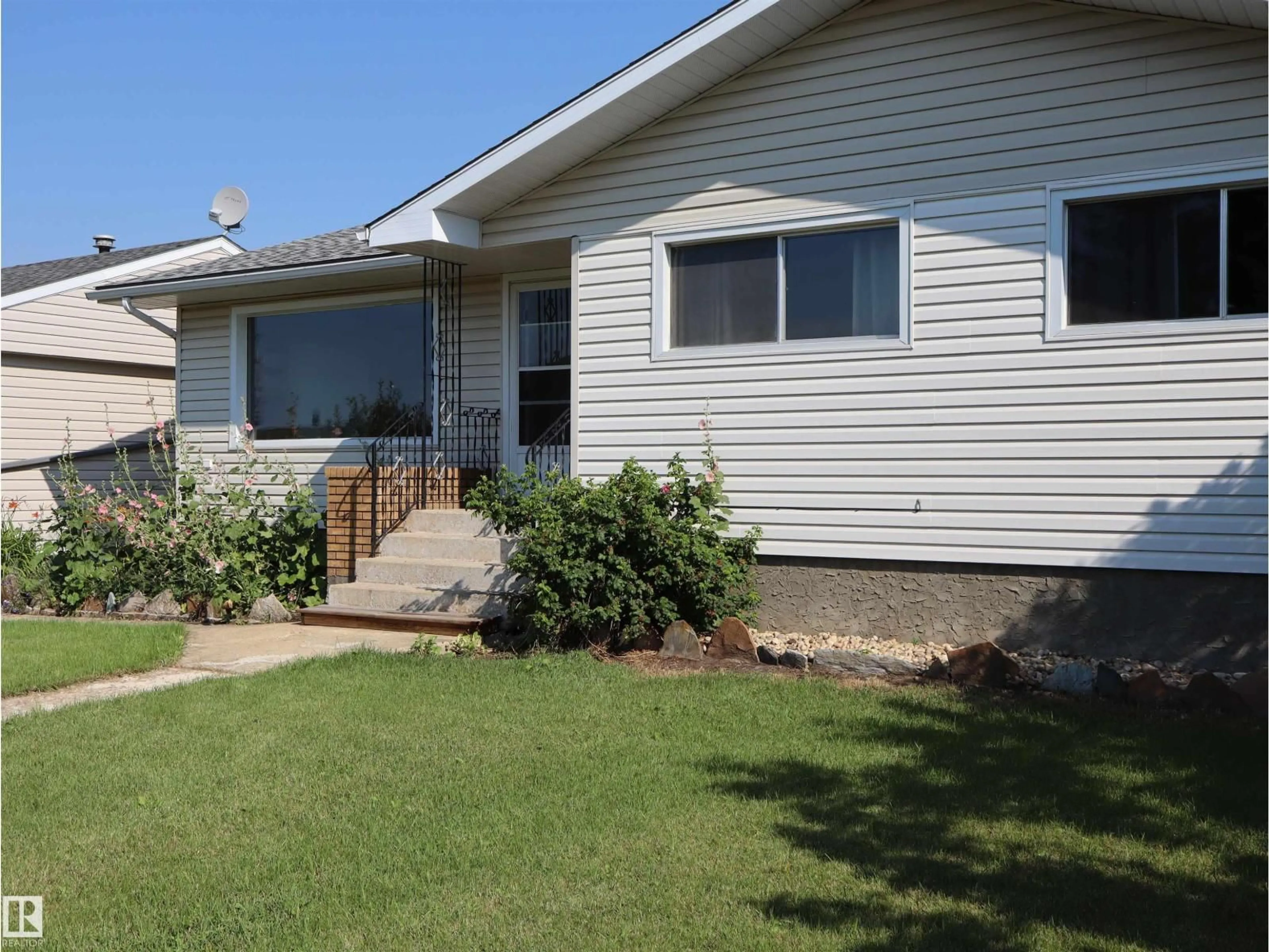 Home with vinyl exterior material, street for 4306 55 AVE, Barrhead Alberta T7N1K1