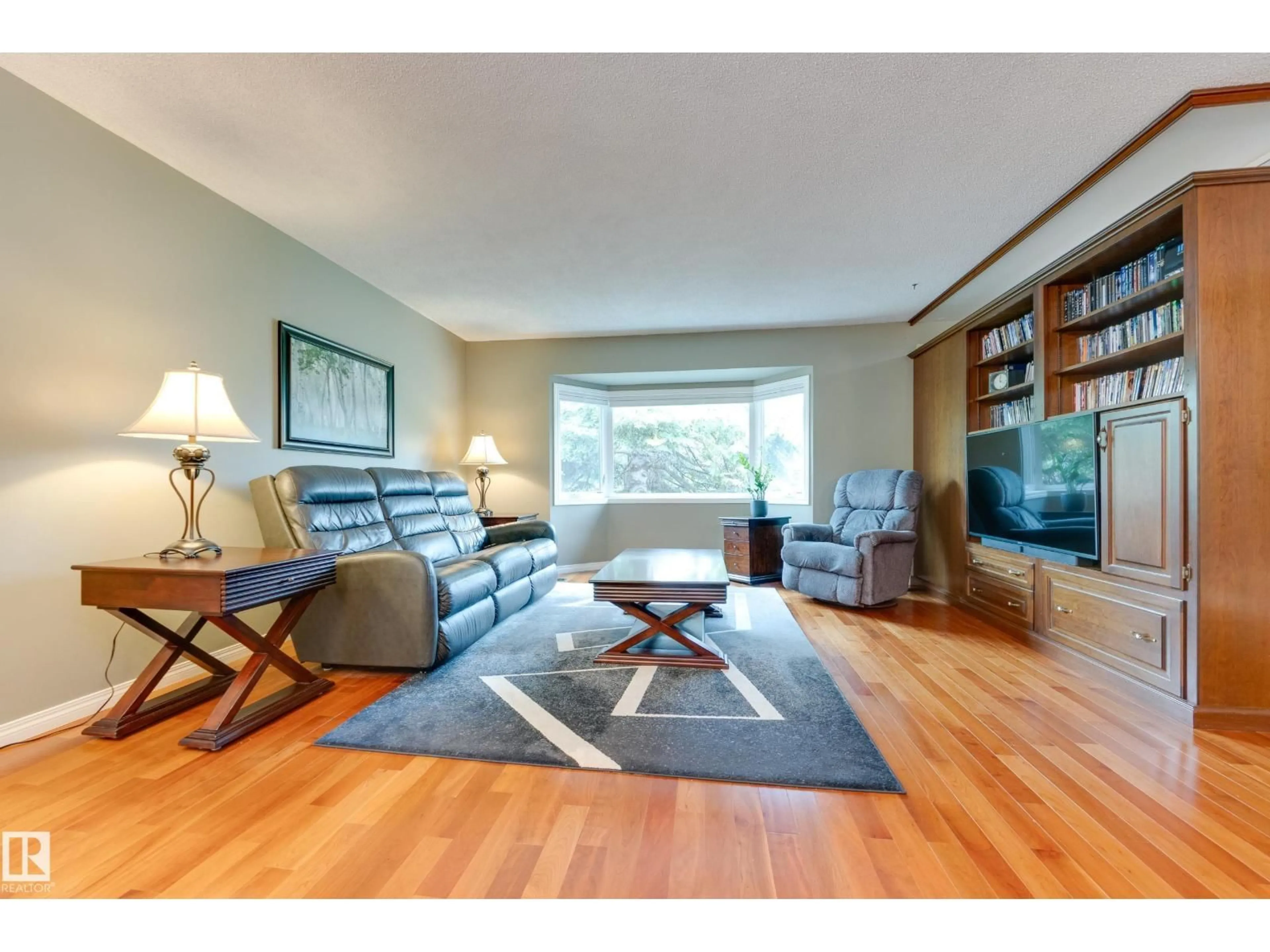 Living room with furniture, wood/laminate floor for 5203 105 ST, Edmonton Alberta T6H2N7