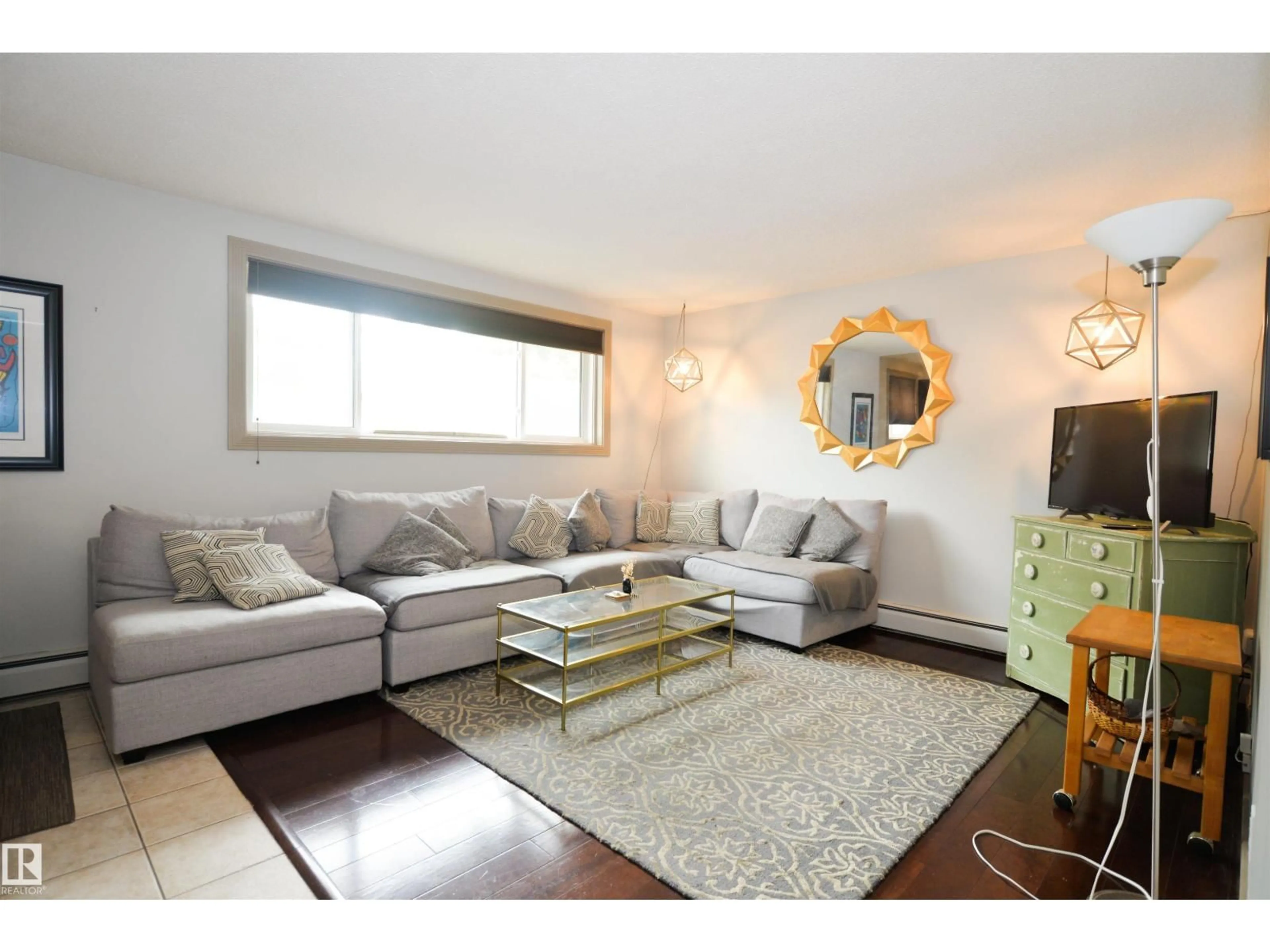 Living room with furniture, wood/laminate floor for 10710 84 AV, Edmonton Alberta T6E2H9