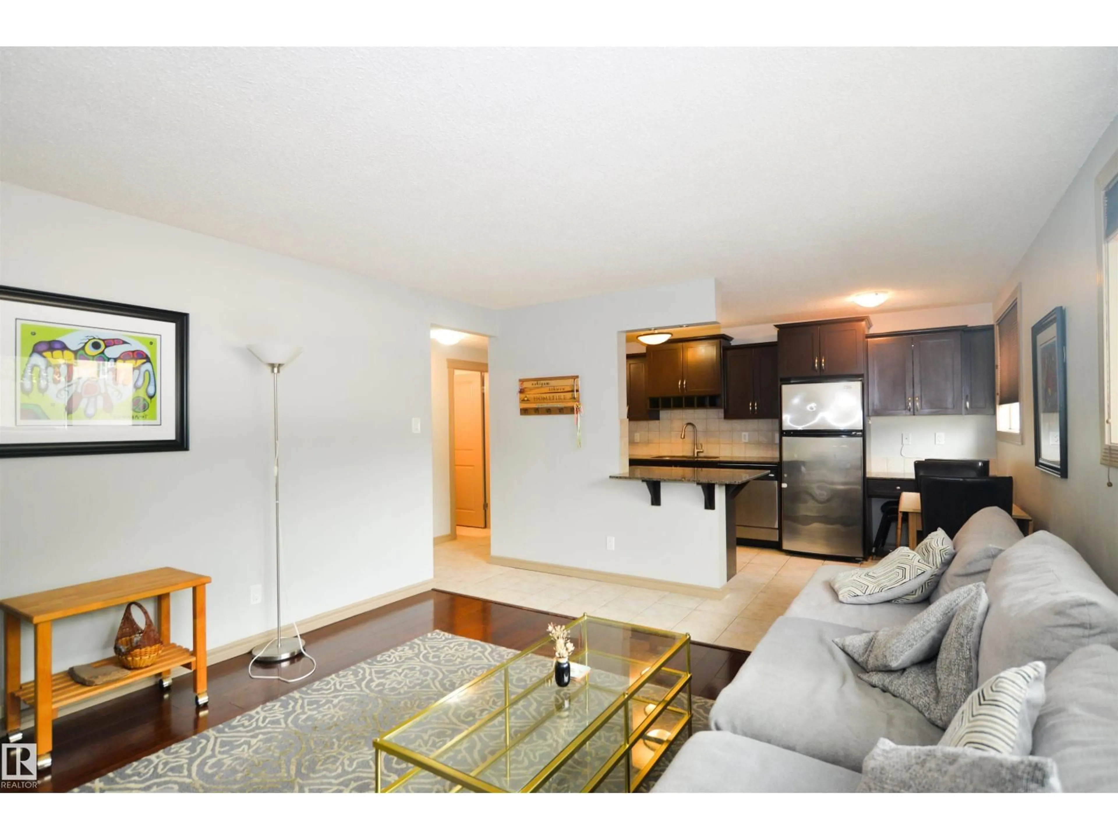 Living room with furniture, wood/laminate floor for 10710 84 AV, Edmonton Alberta T6E2H9