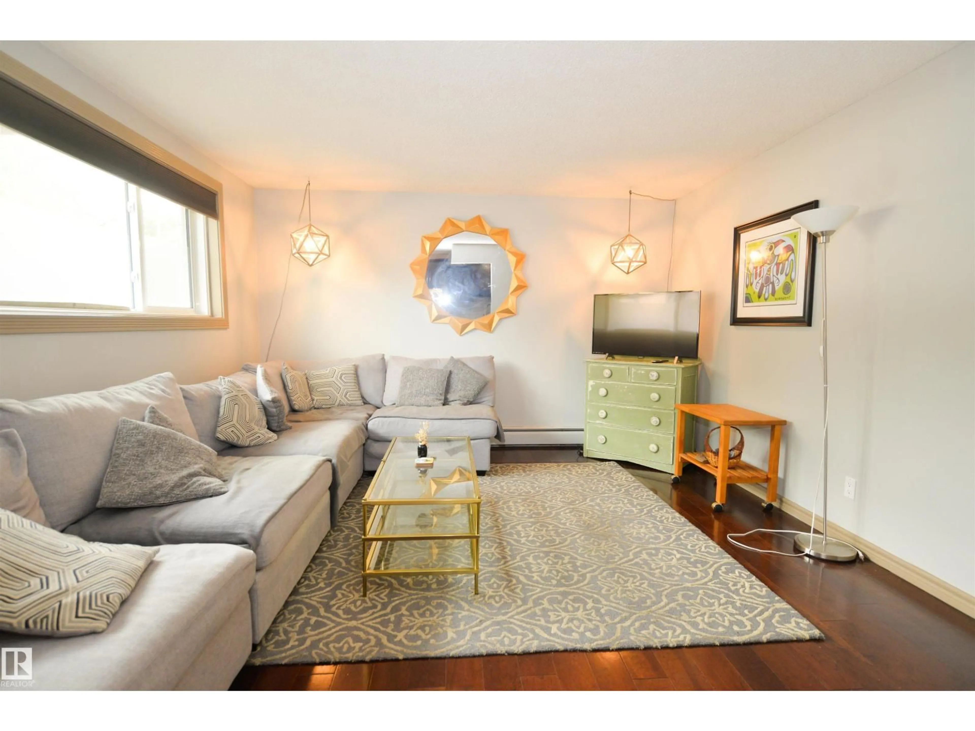 Living room with furniture, wood/laminate floor for 10710 84 AV, Edmonton Alberta T6E2H9