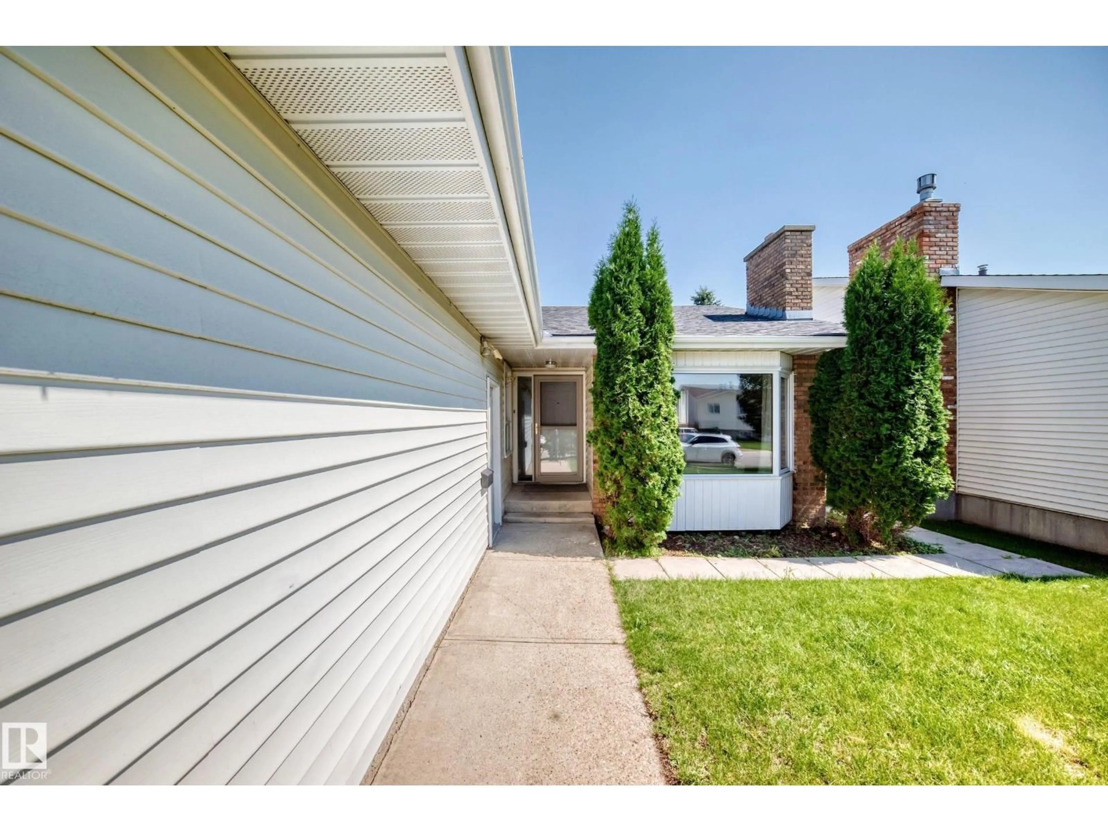 Home with vinyl exterior material, street for 6208 11 AVE NW, Edmonton Alberta T6L2G4