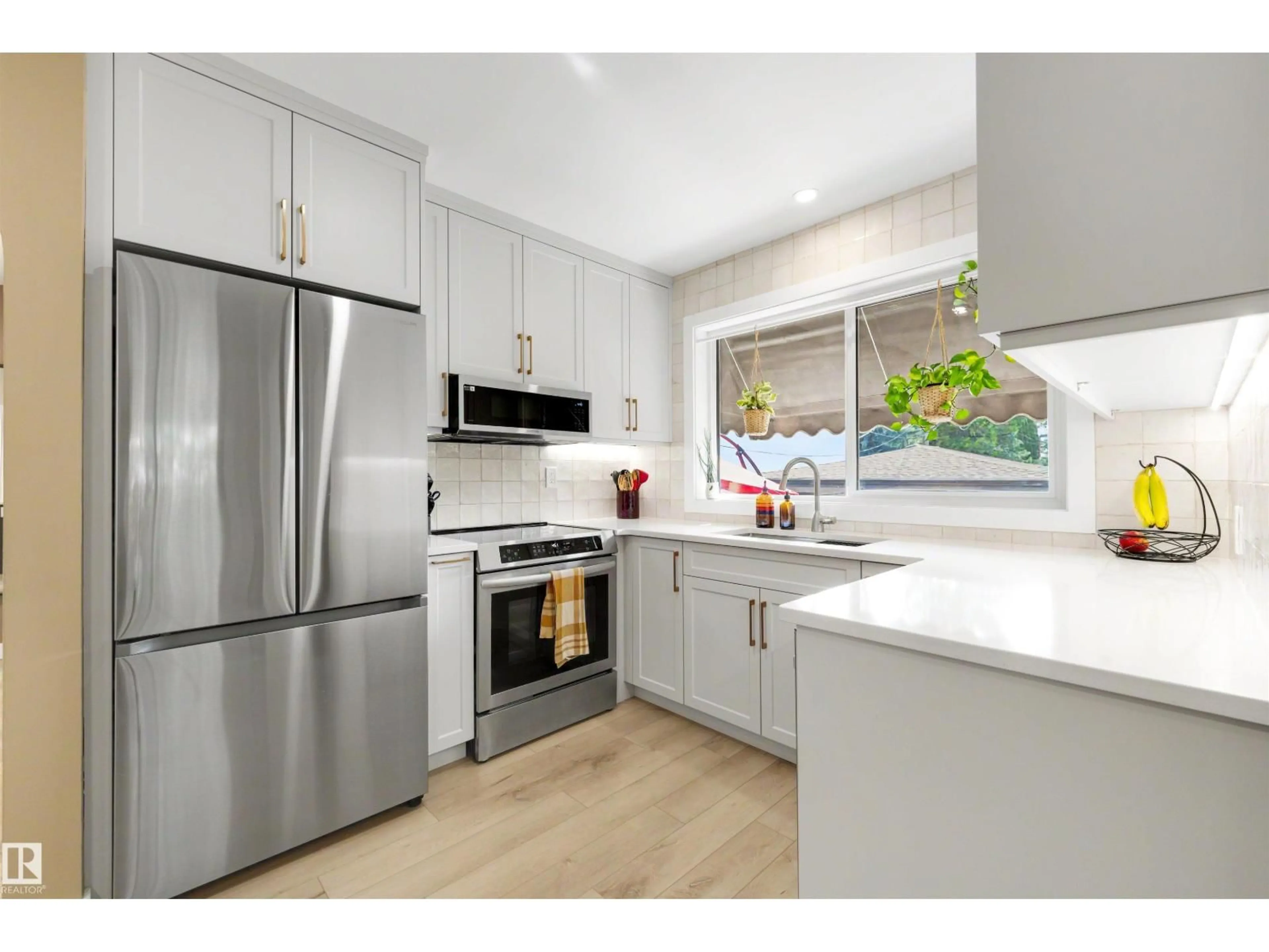 Open concept kitchen, wood/laminate floor for NW - 10732 129 ST, Edmonton Alberta T5M0X5