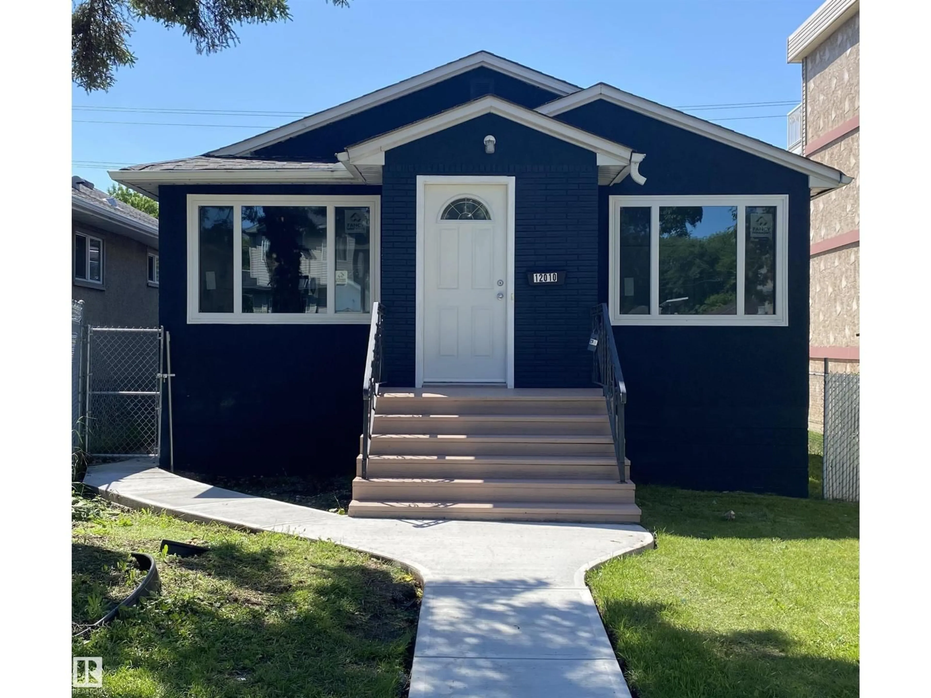 Home with vinyl exterior material, street for NW - 12010 66 ST, Edmonton Alberta T5B1J6