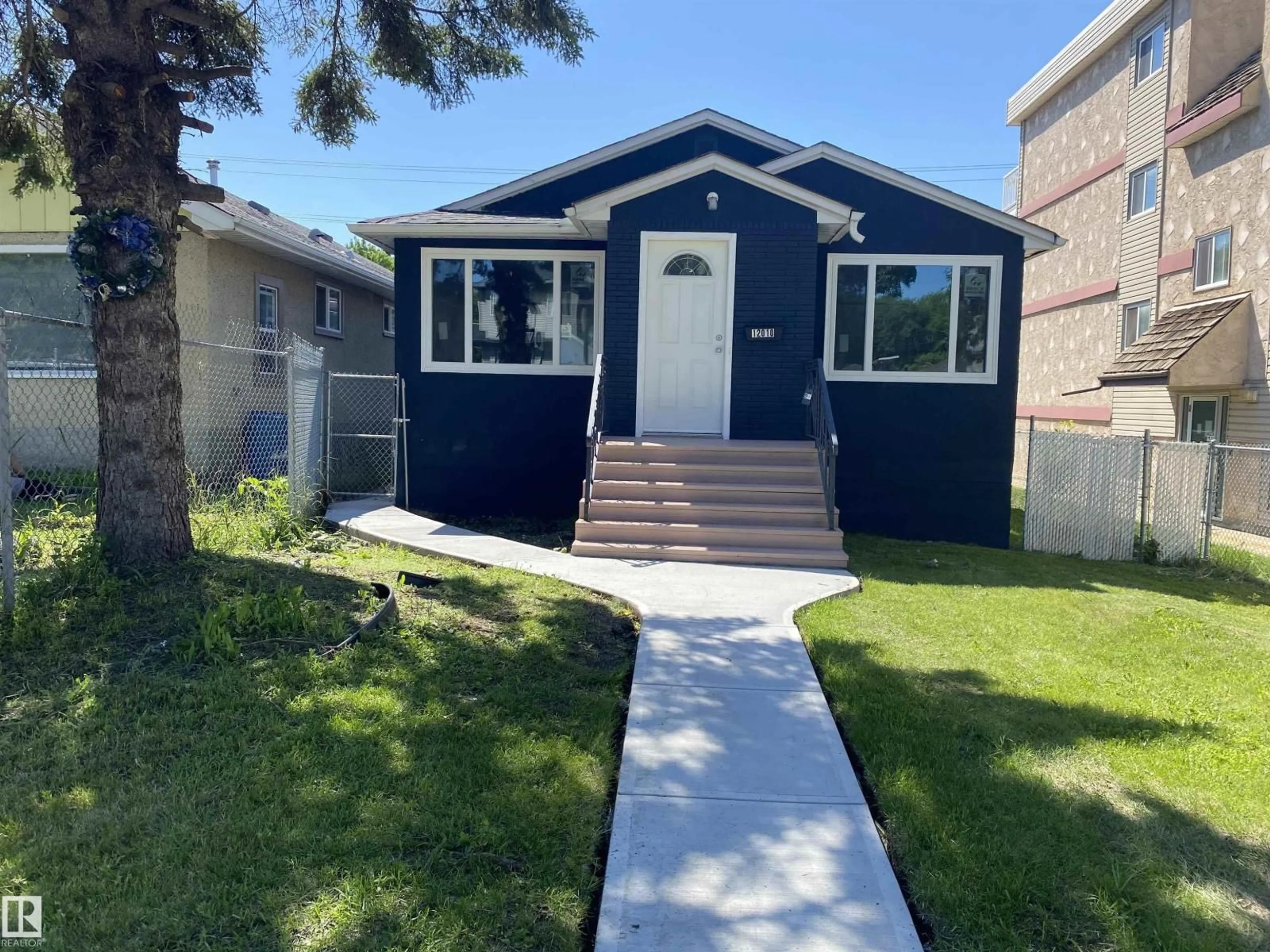 Home with vinyl exterior material, street for NW - 12010 66 ST, Edmonton Alberta T5B1J6