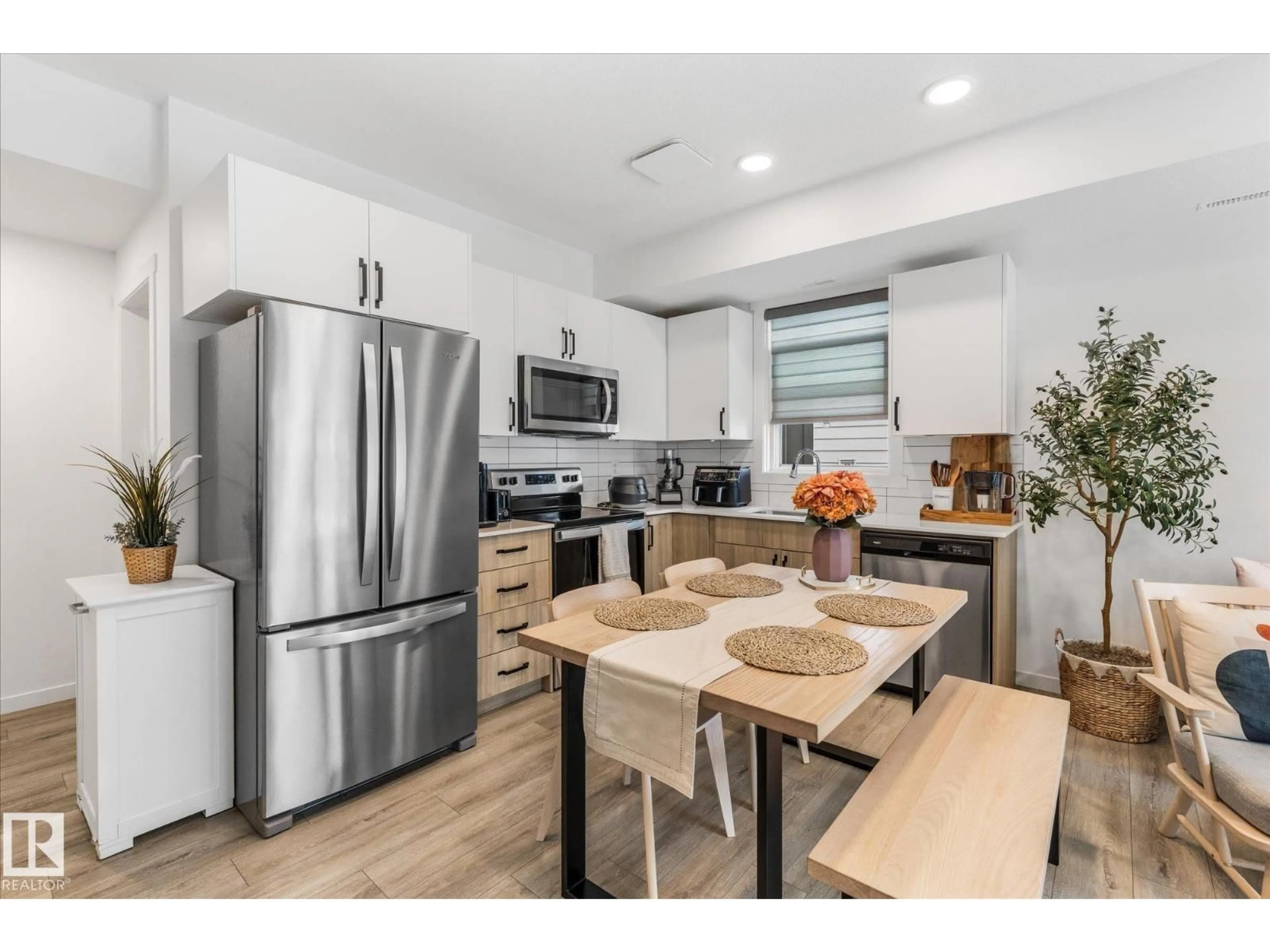 Open concept kitchen, wood/laminate floor for #104 - 860 SECORD BV, Edmonton Alberta T5T7R9