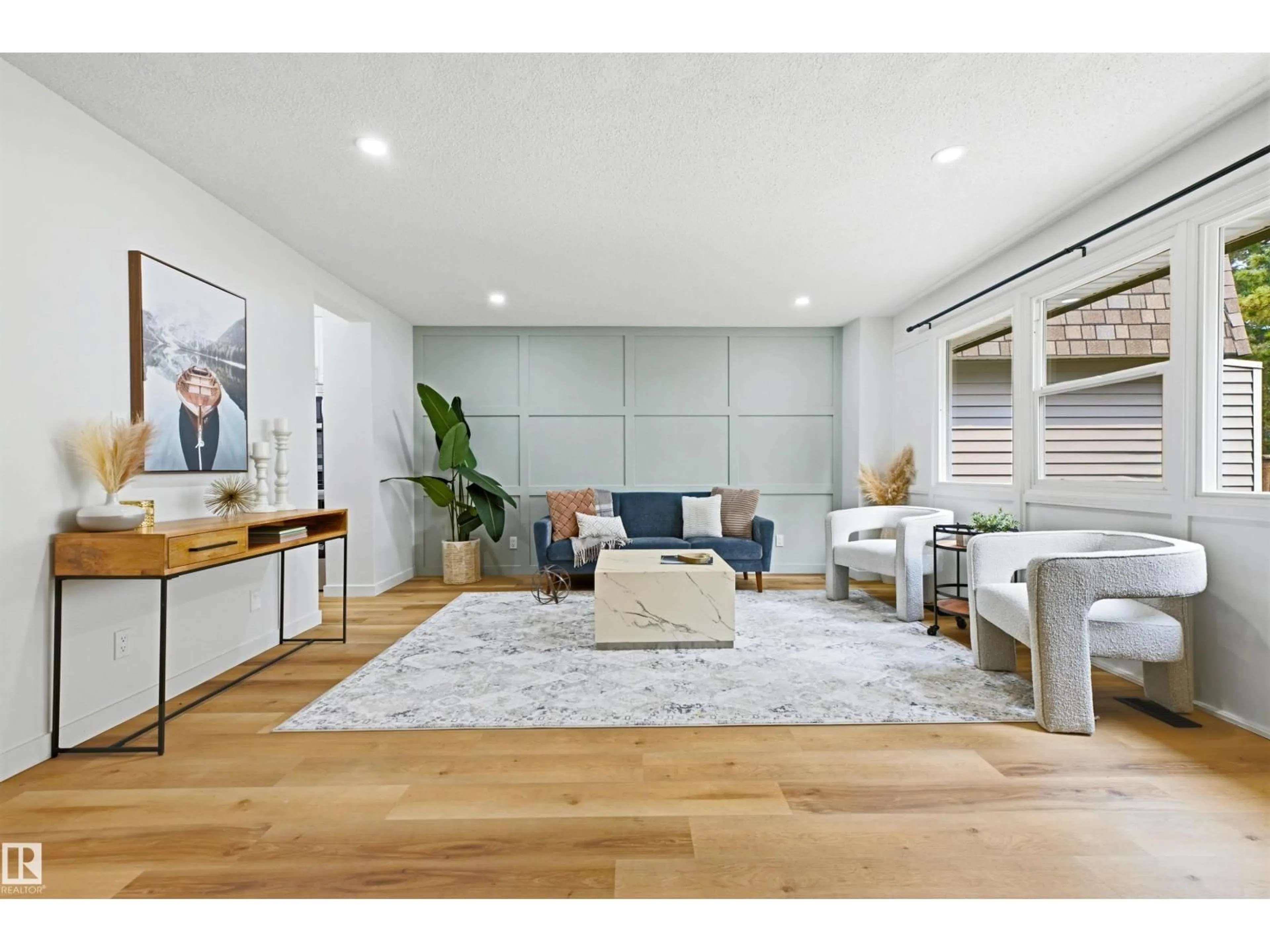Living room with furniture, wood/laminate floor for 414 VILLAGE ON THE GR NW, Edmonton Alberta T5A1H2