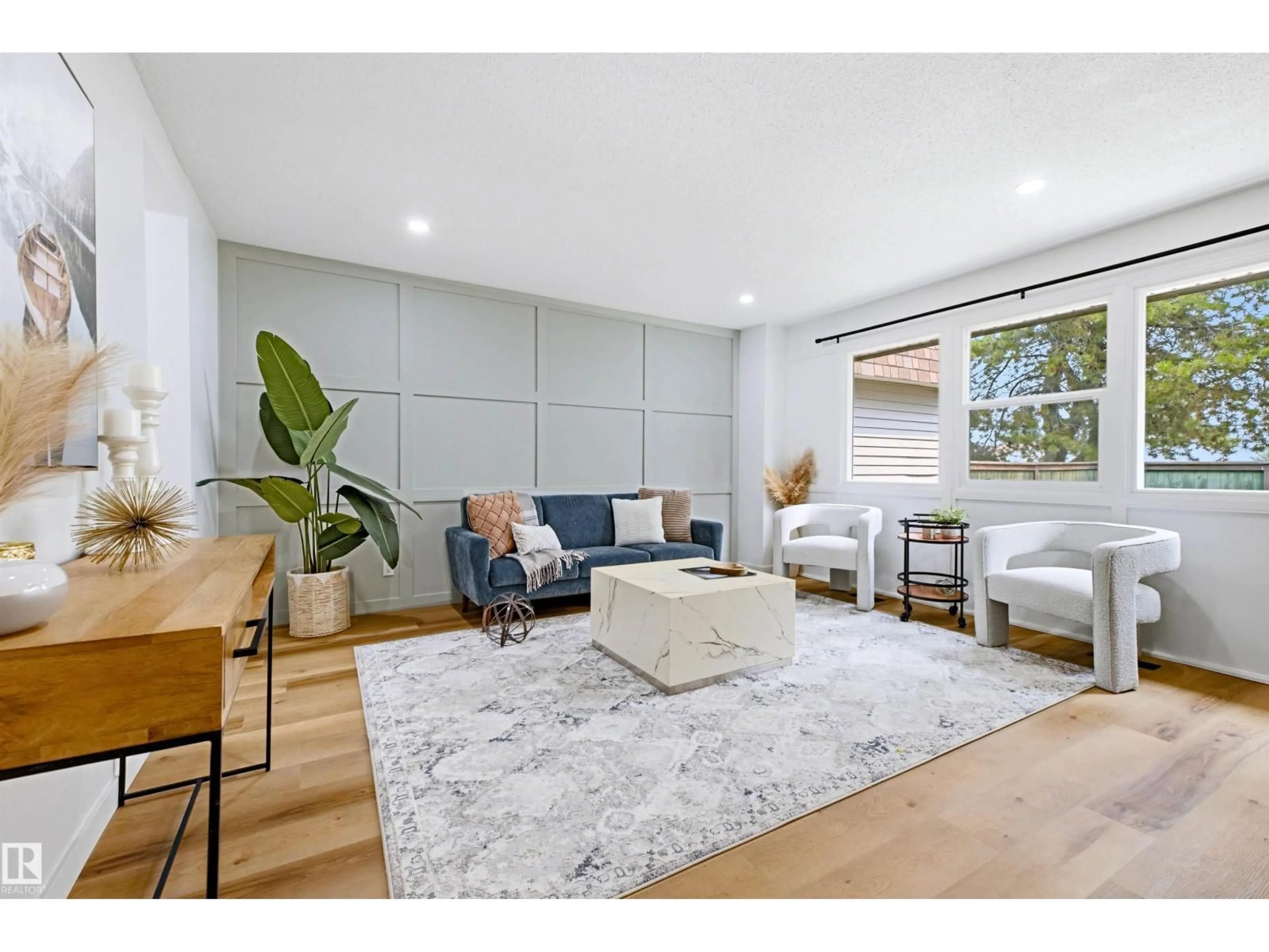 Living room with furniture, wood/laminate floor for 414 VILLAGE ON THE GR NW, Edmonton Alberta T5A1H2