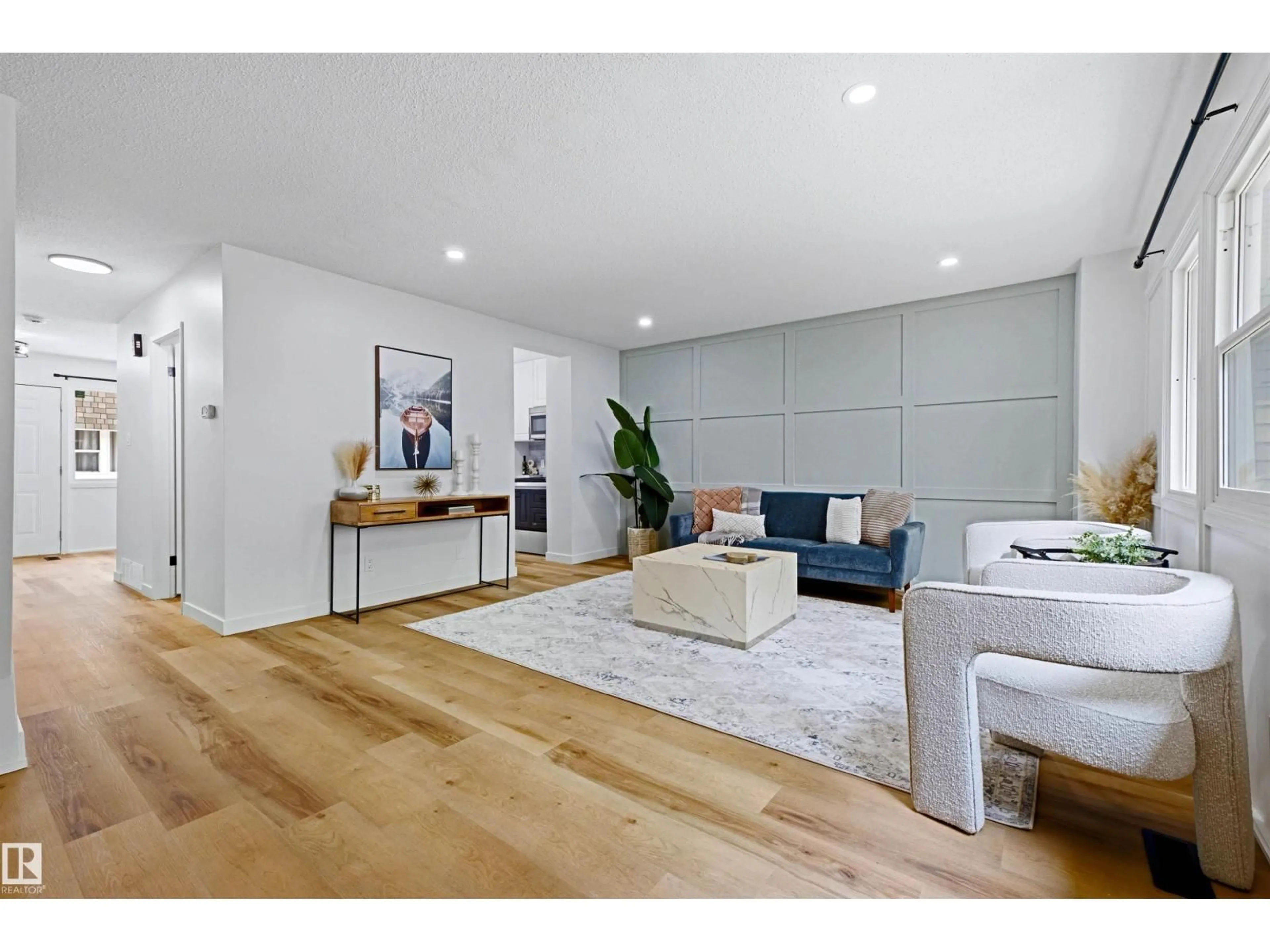 Living room with furniture, wood/laminate floor for 414 VILLAGE ON THE GR NW, Edmonton Alberta T5A1H2