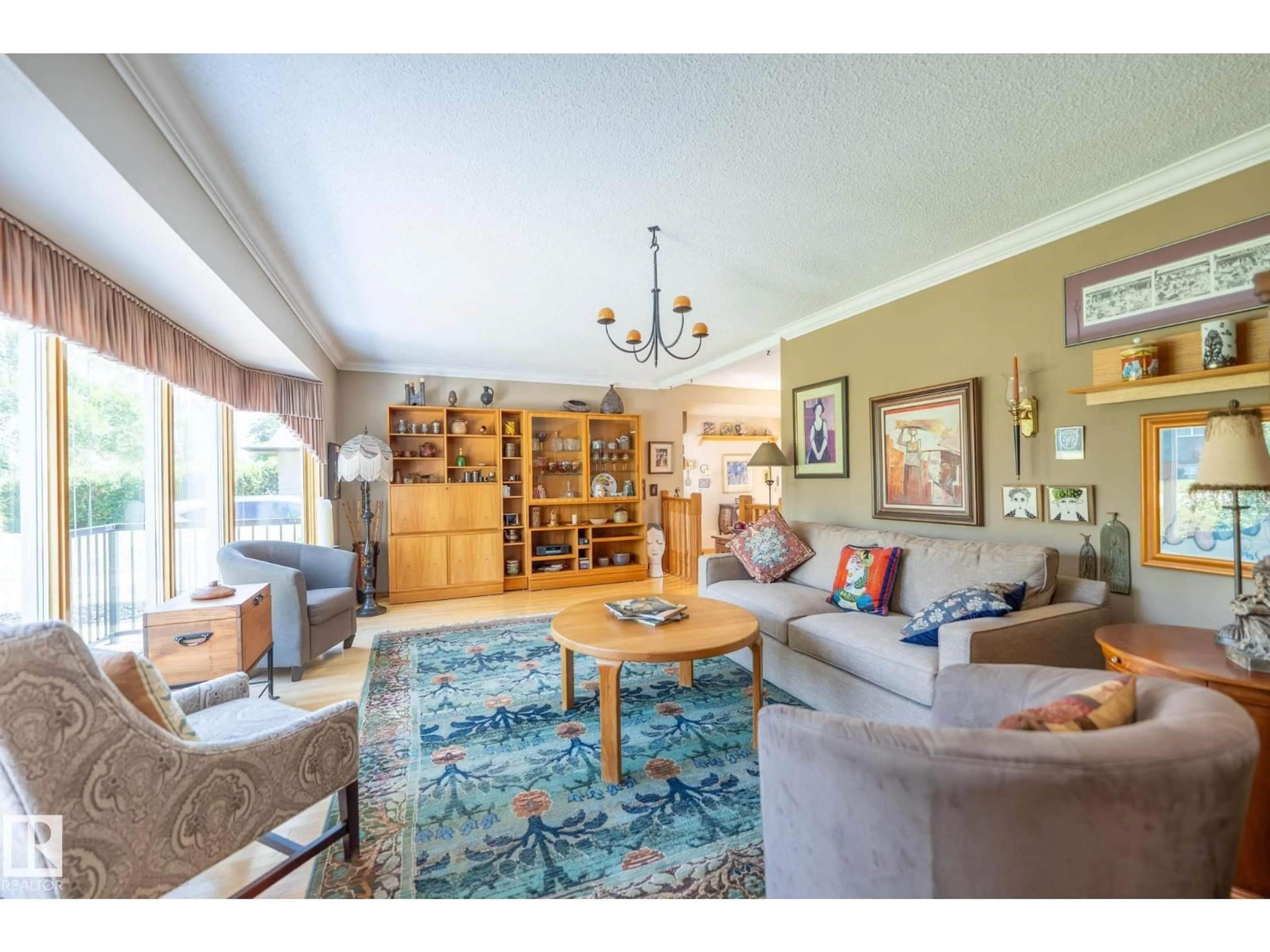 Living room with furniture, wood/laminate floor for 4707 105A AV, Edmonton Alberta T6A1C1