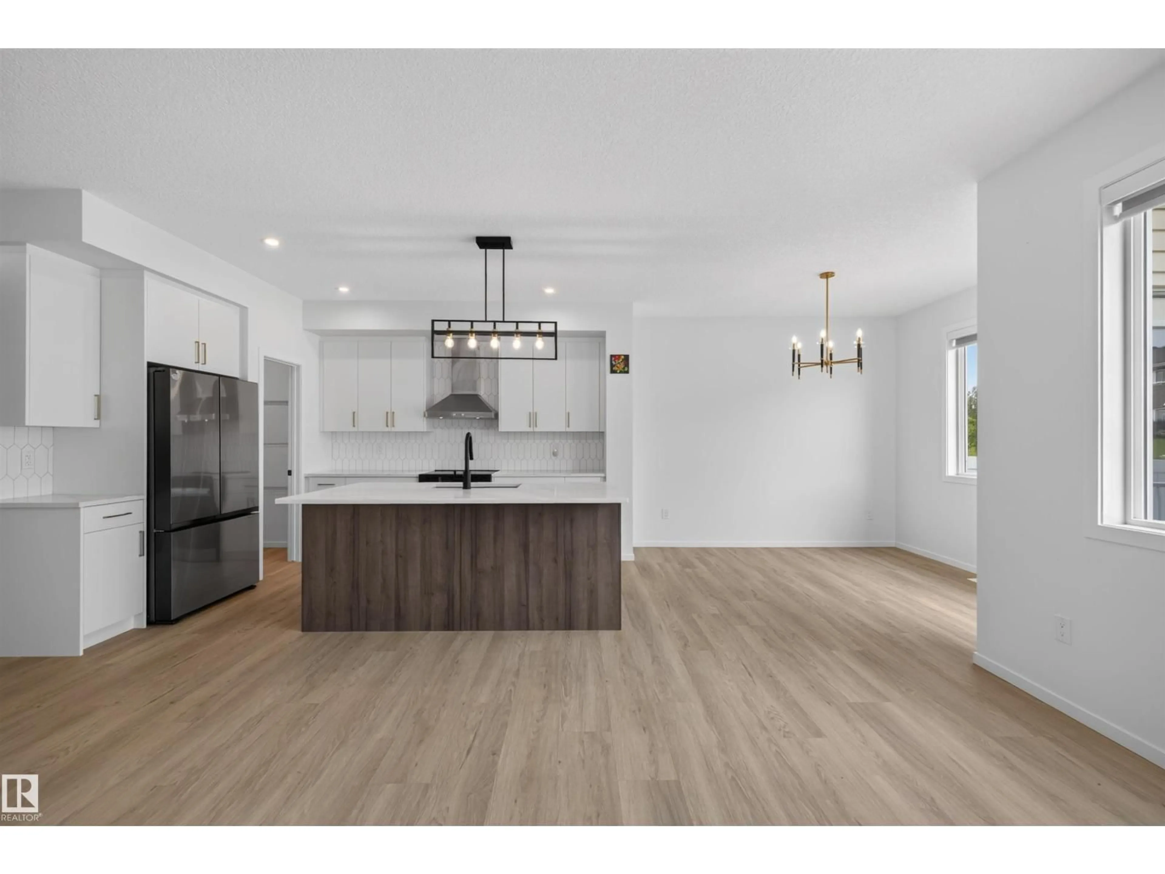 Open concept kitchen, wood/laminate floor for 7722 174A AV, Edmonton Alberta T5Z0W5