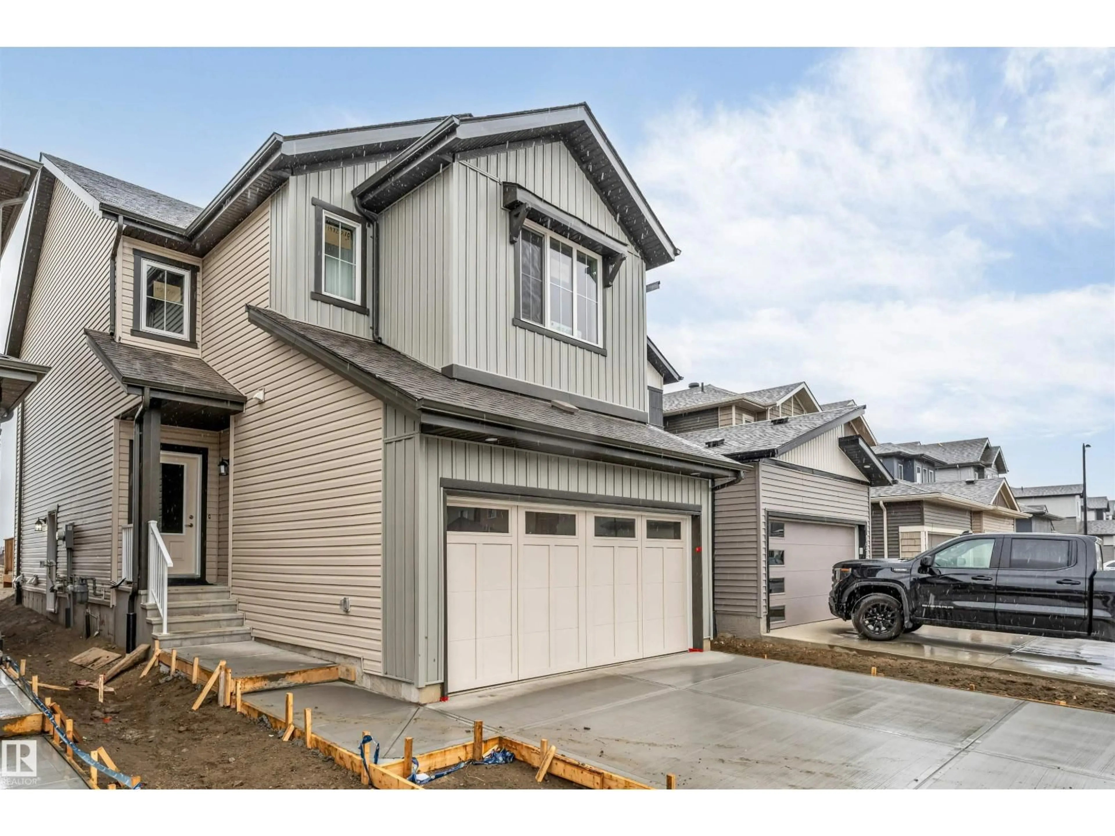 Home with vinyl exterior material, street for NW - 1972 210 ST, Edmonton Alberta T6M3H5