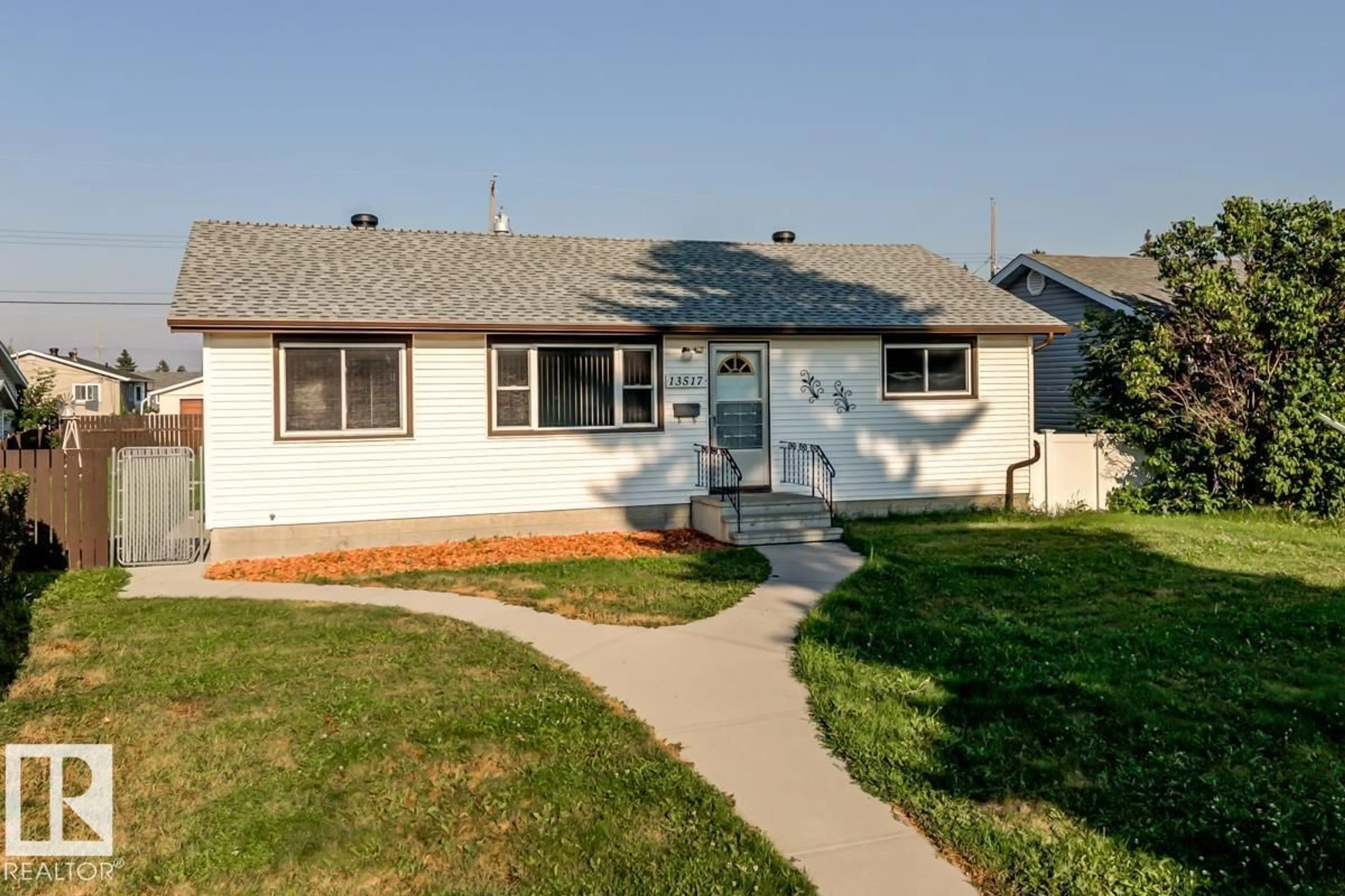 Home with vinyl exterior material, street for 13517 136 ST, Edmonton Alberta T5L2A2