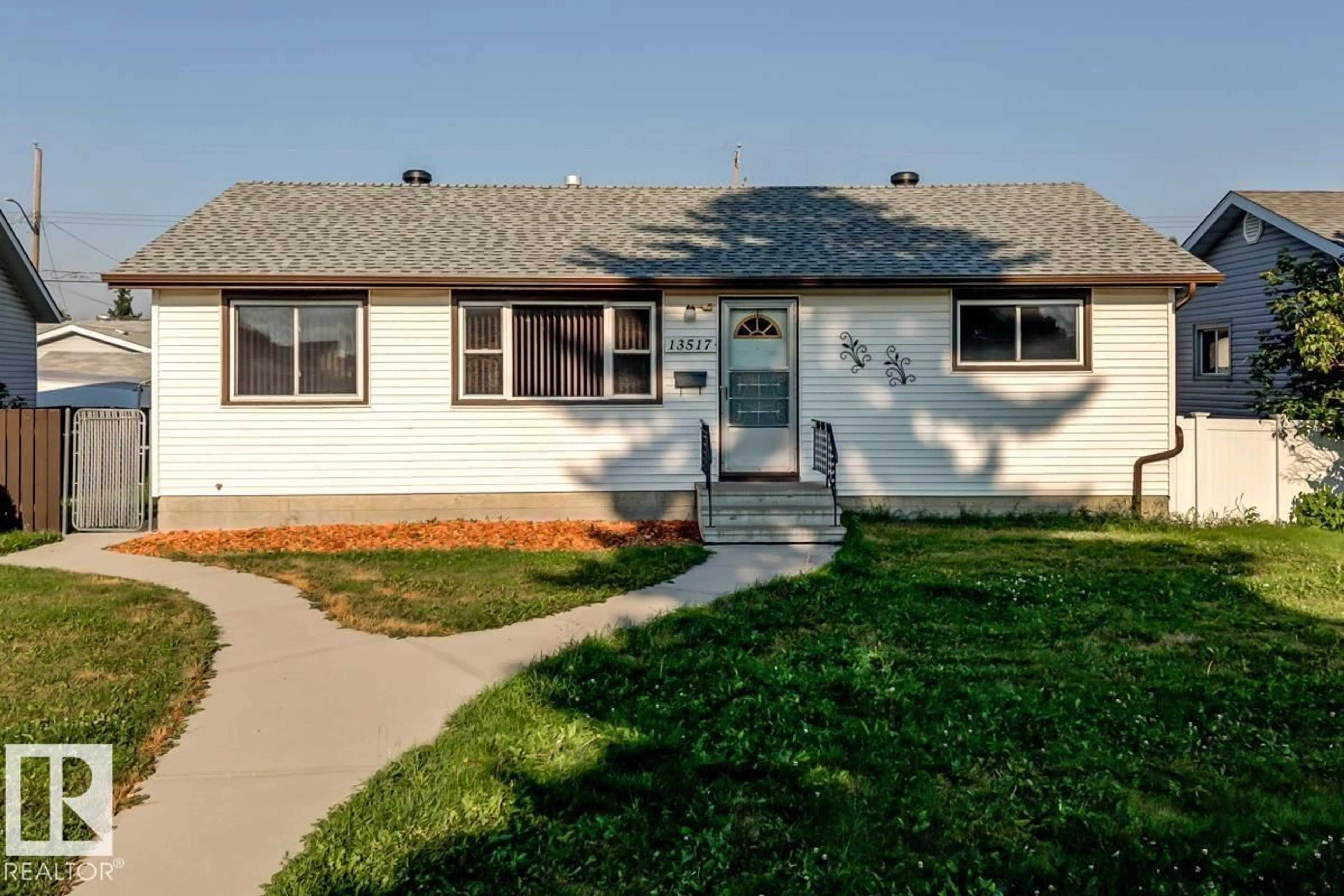 Home with vinyl exterior material, street for 13517 136 ST, Edmonton Alberta T5L2A2