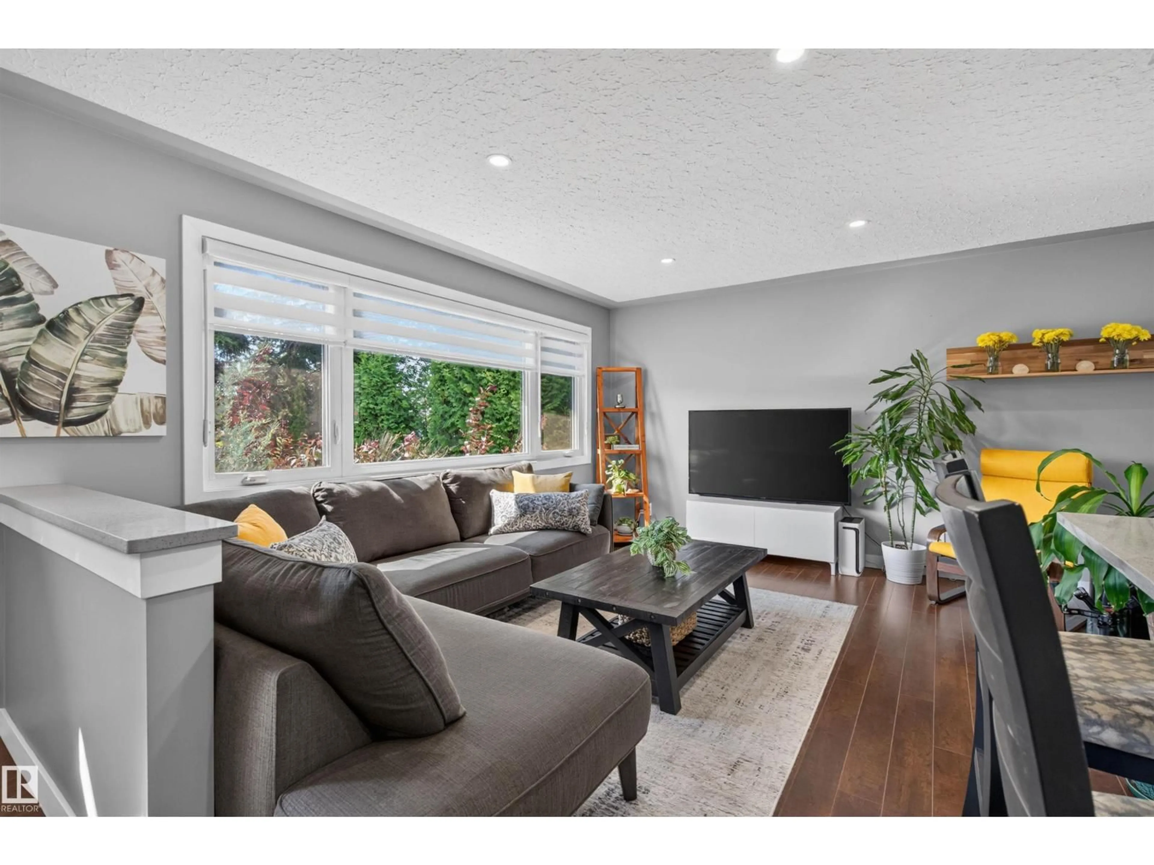 Living room with furniture, wood/laminate floor for NW - 12136 135A AV, Edmonton Alberta T5L3Z3