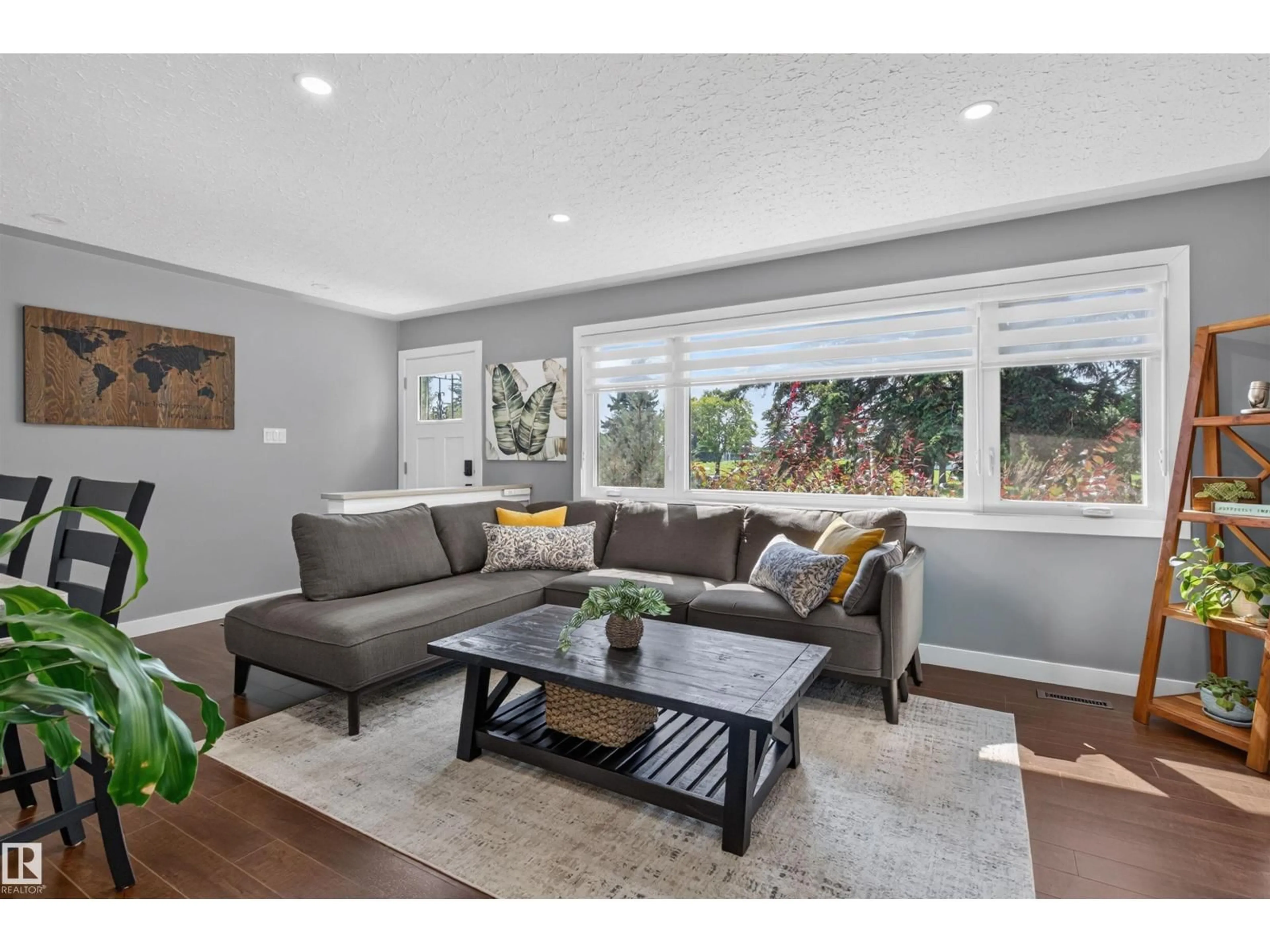 Living room with furniture, wood/laminate floor for NW - 12136 135A AV, Edmonton Alberta T5L3Z3