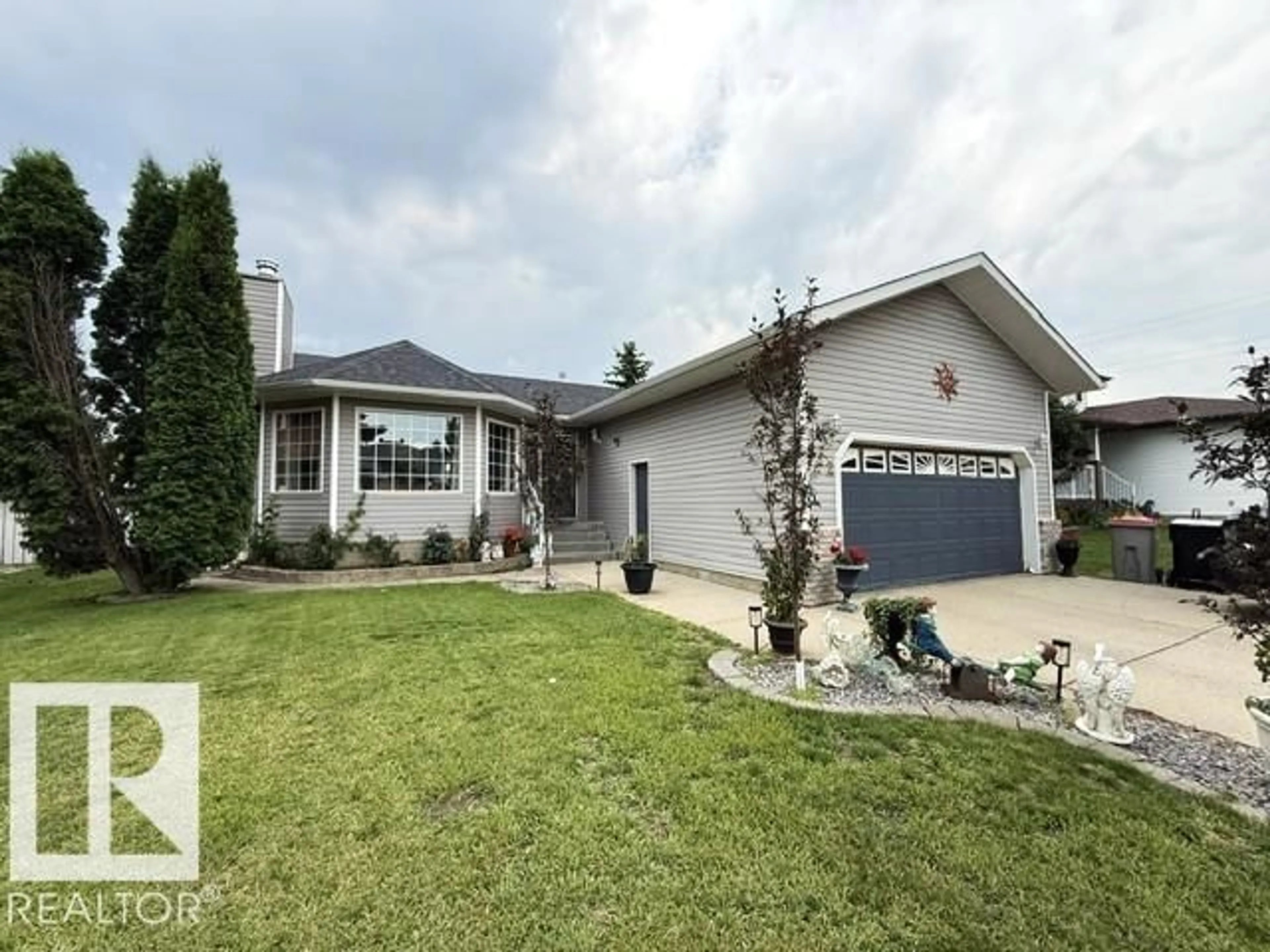 Home with vinyl exterior material, street for 212 WEST LIBERTY CR, Millet Alberta T0C1Z0