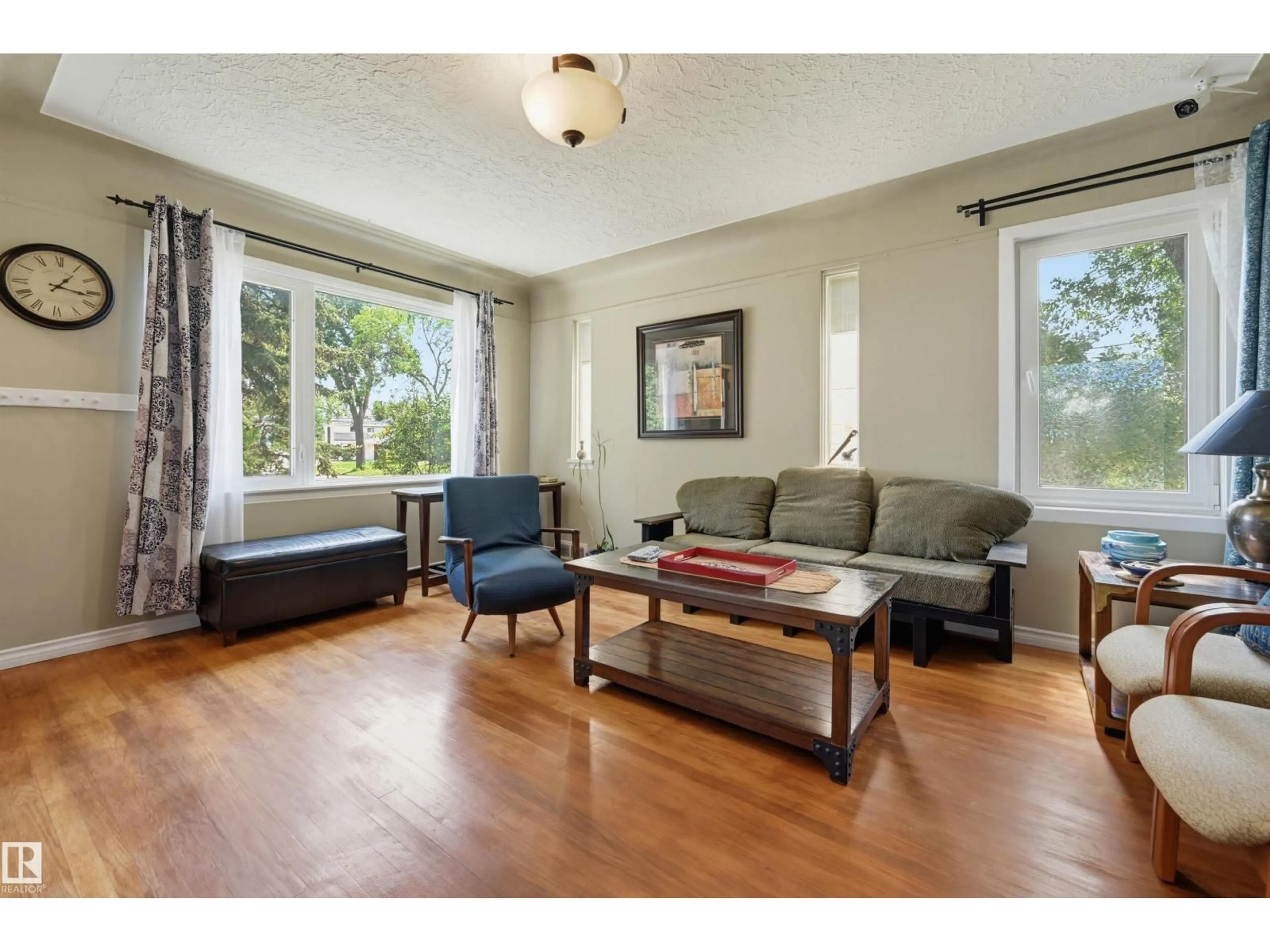 Living room with furniture, wood/laminate floor for NW - 11502 127 ST, Edmonton Alberta T5M0V3