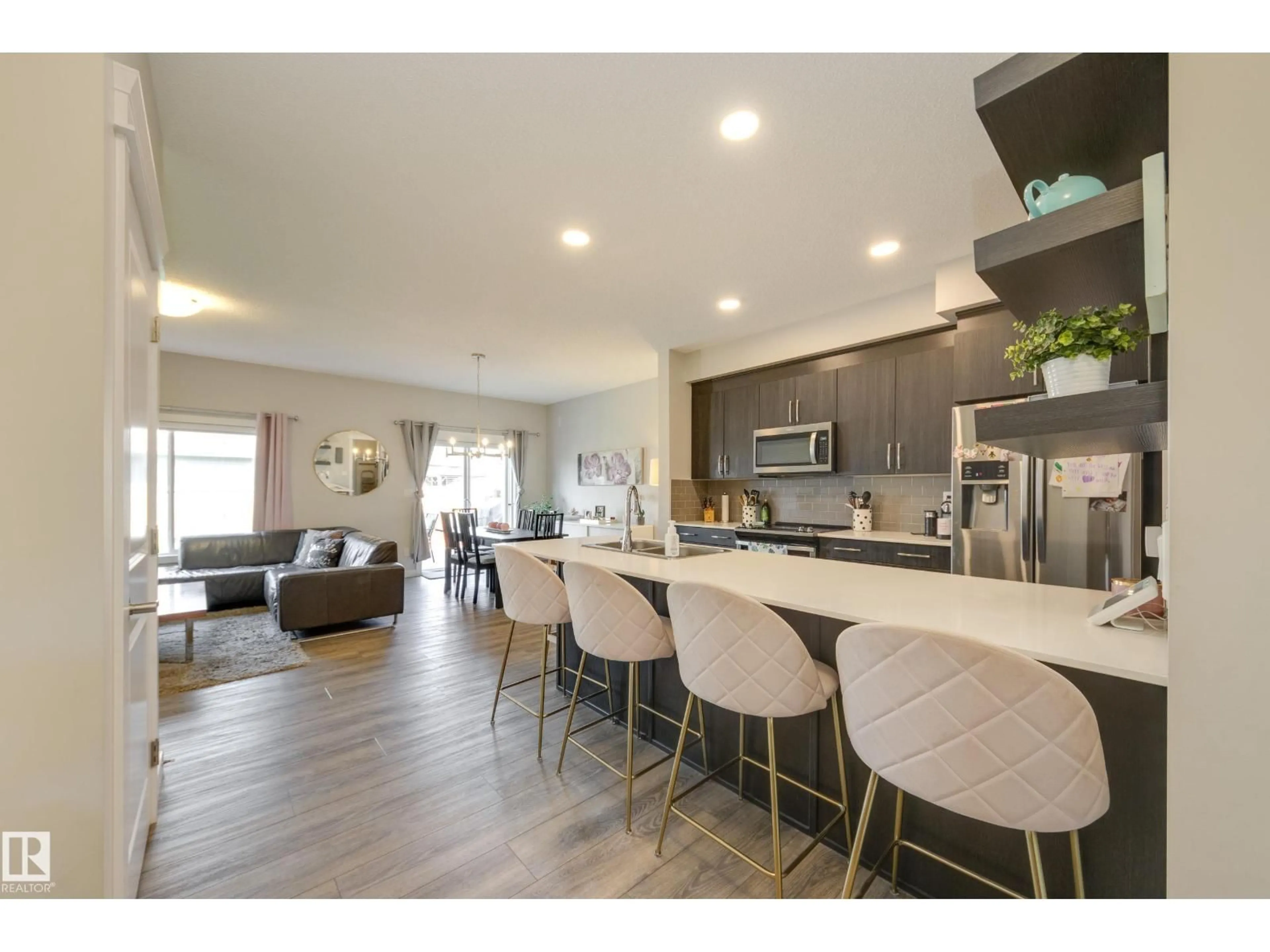 Open concept kitchen, wood/laminate floor for 9932 223 ST, Edmonton Alberta T5T7L7