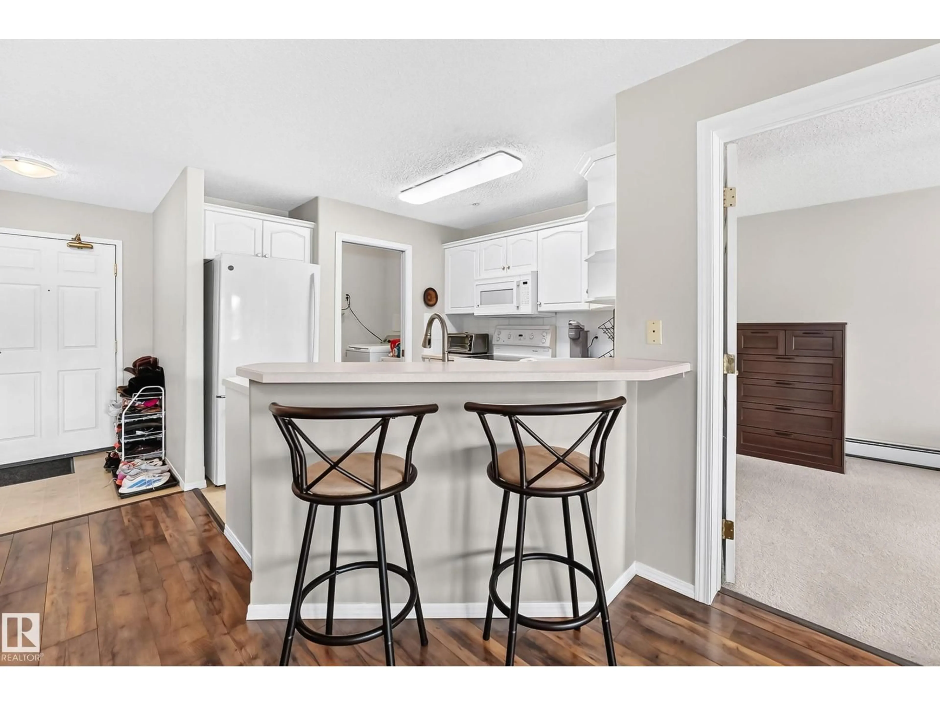 Open concept kitchen, wood/laminate floor for #201 - 9760 174 ST, Edmonton Alberta T5T6J4
