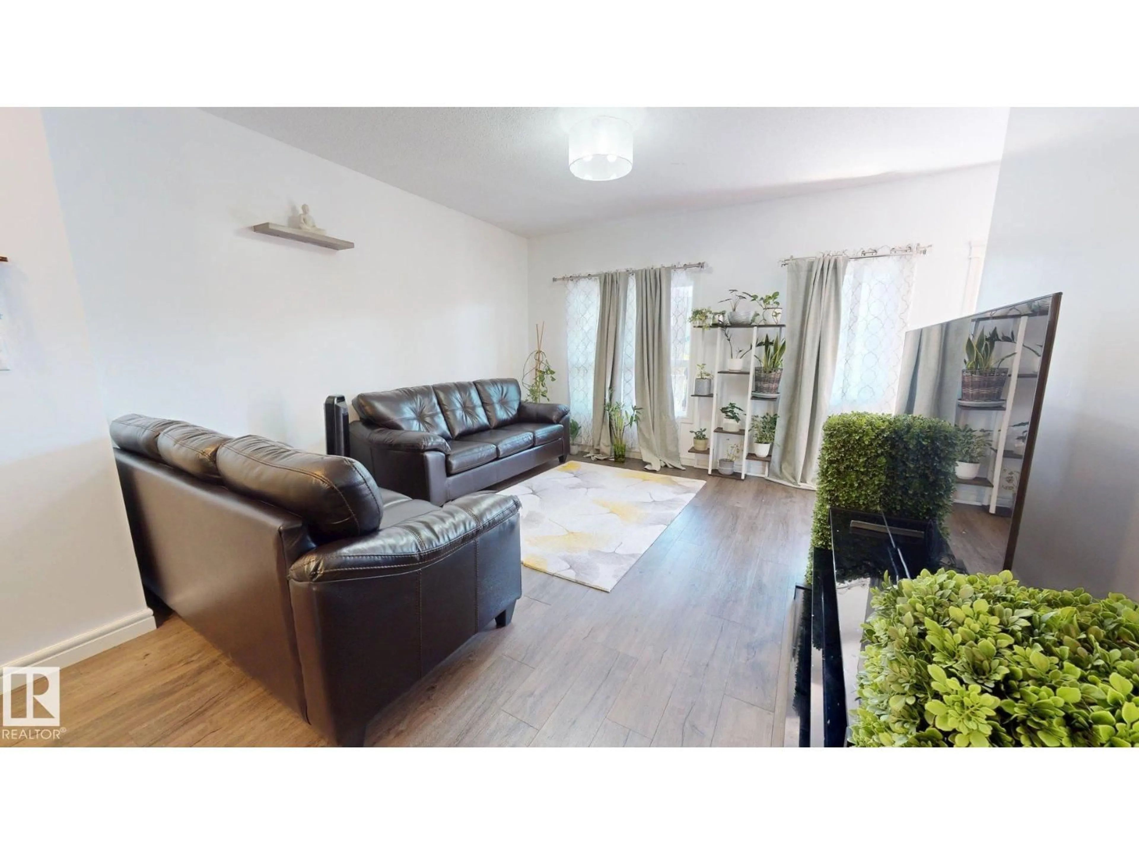 Living room with furniture, wood/laminate floor for NW - 8172 226 ST, Edmonton Alberta T5T7G7