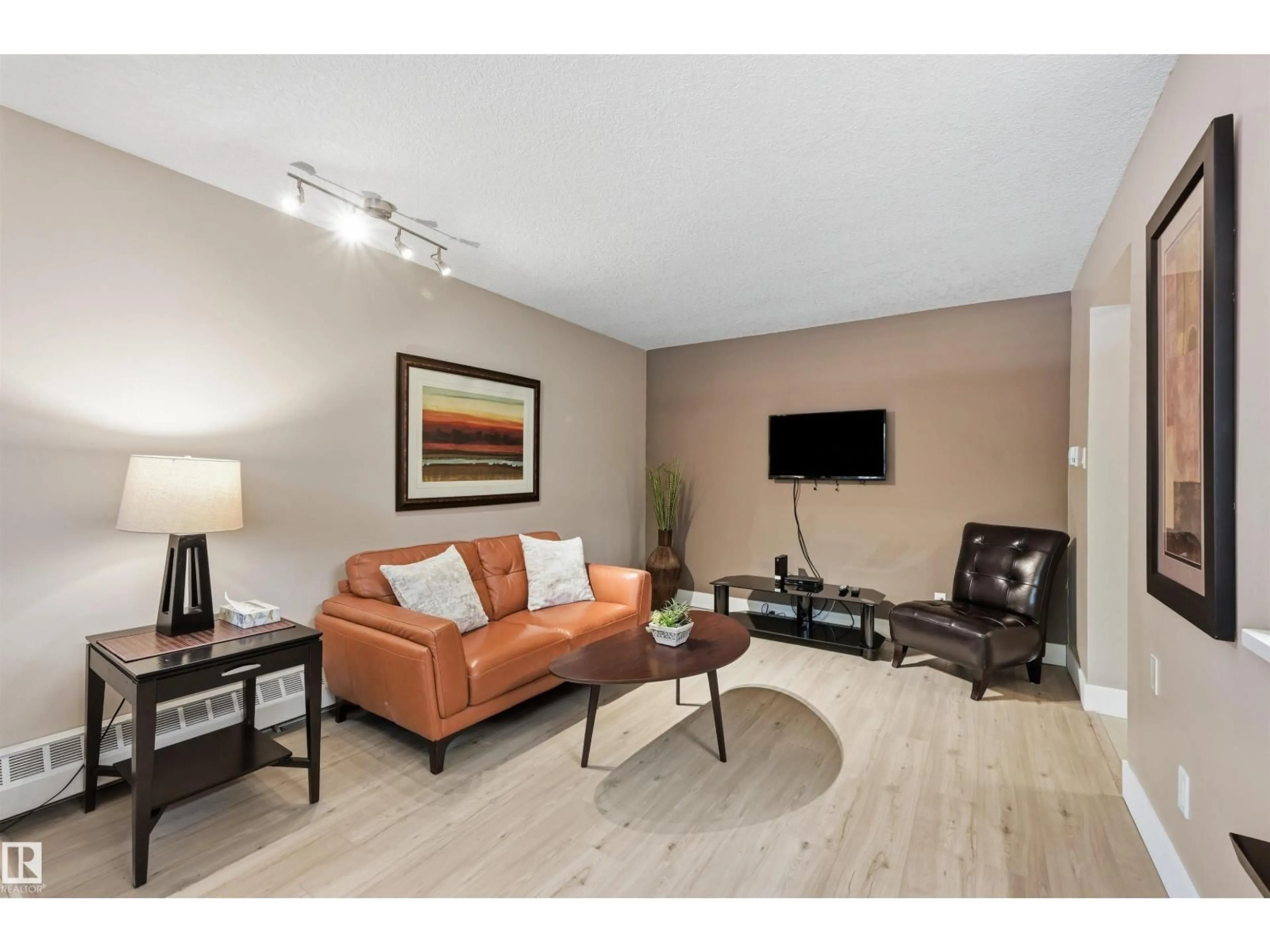 Living room with furniture, wood/laminate floor for #1 - 10015 83 AV NW, Edmonton Alberta T6E2C3