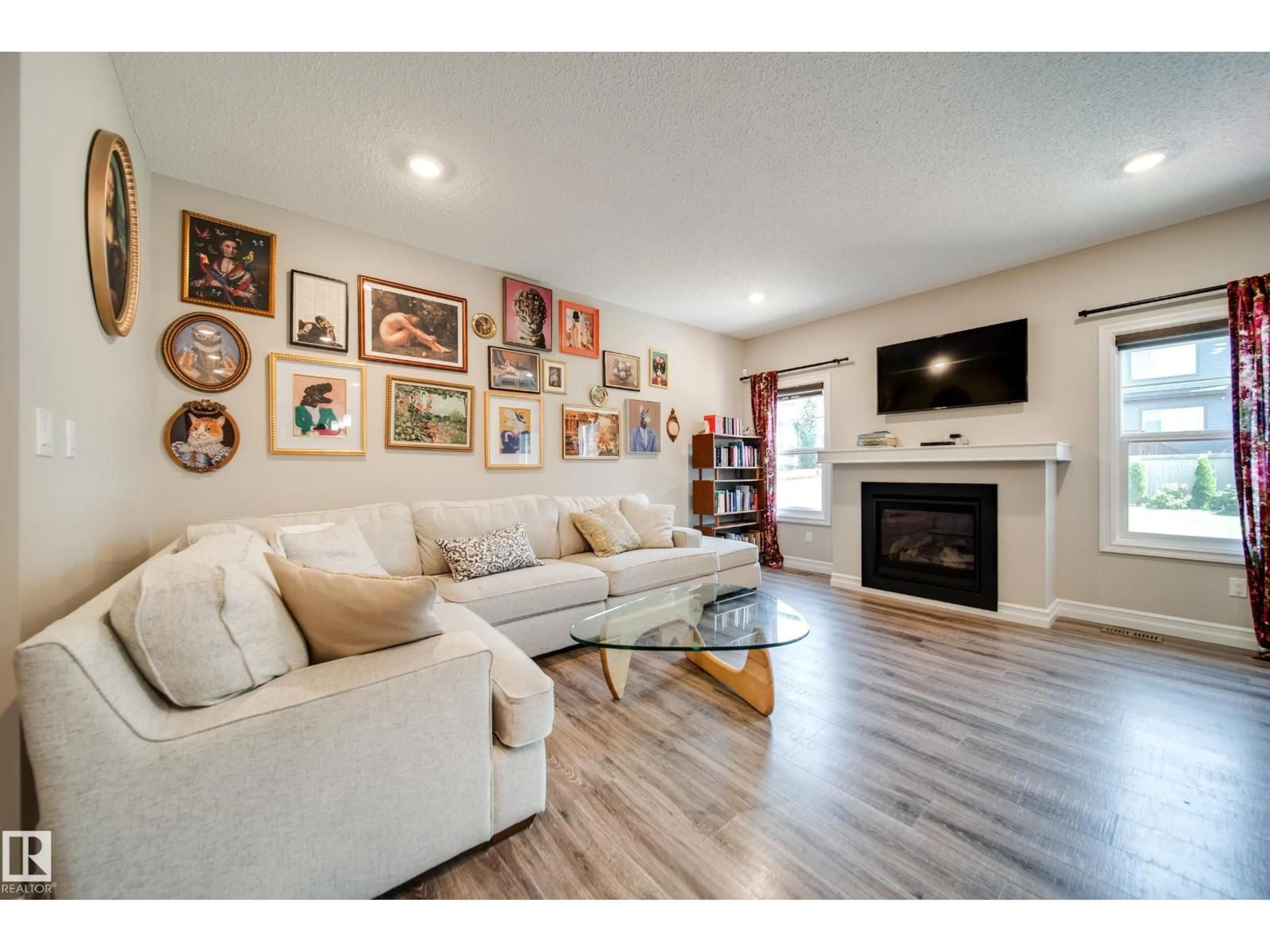 Living room with furniture, wood/laminate floor for 3632 KESWICK BV, Edmonton Alberta T6W3S5