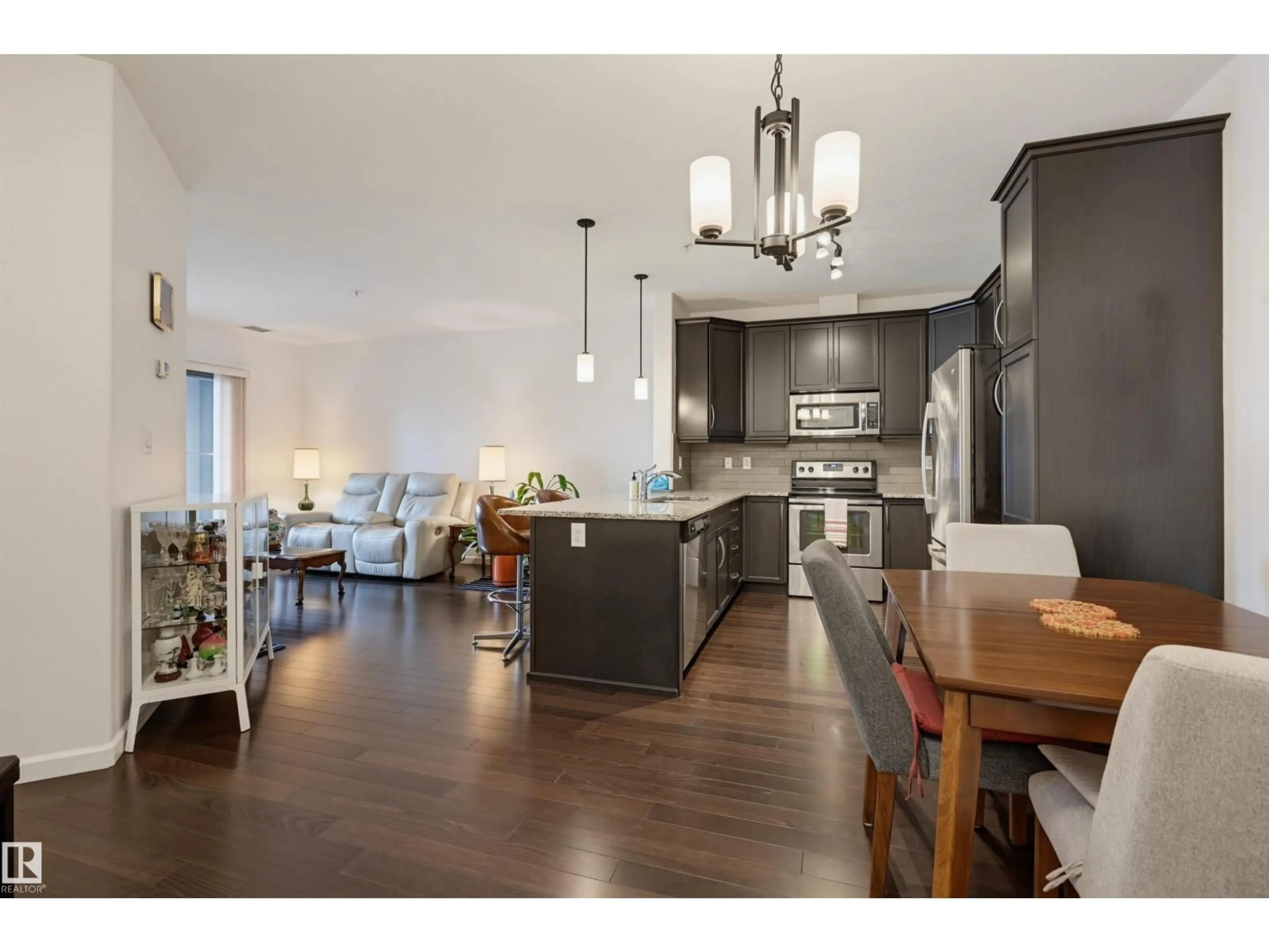 Open concept kitchen, wood/laminate floor for 6083 - 110 MAYNARD WY, Edmonton Alberta T6R0S5