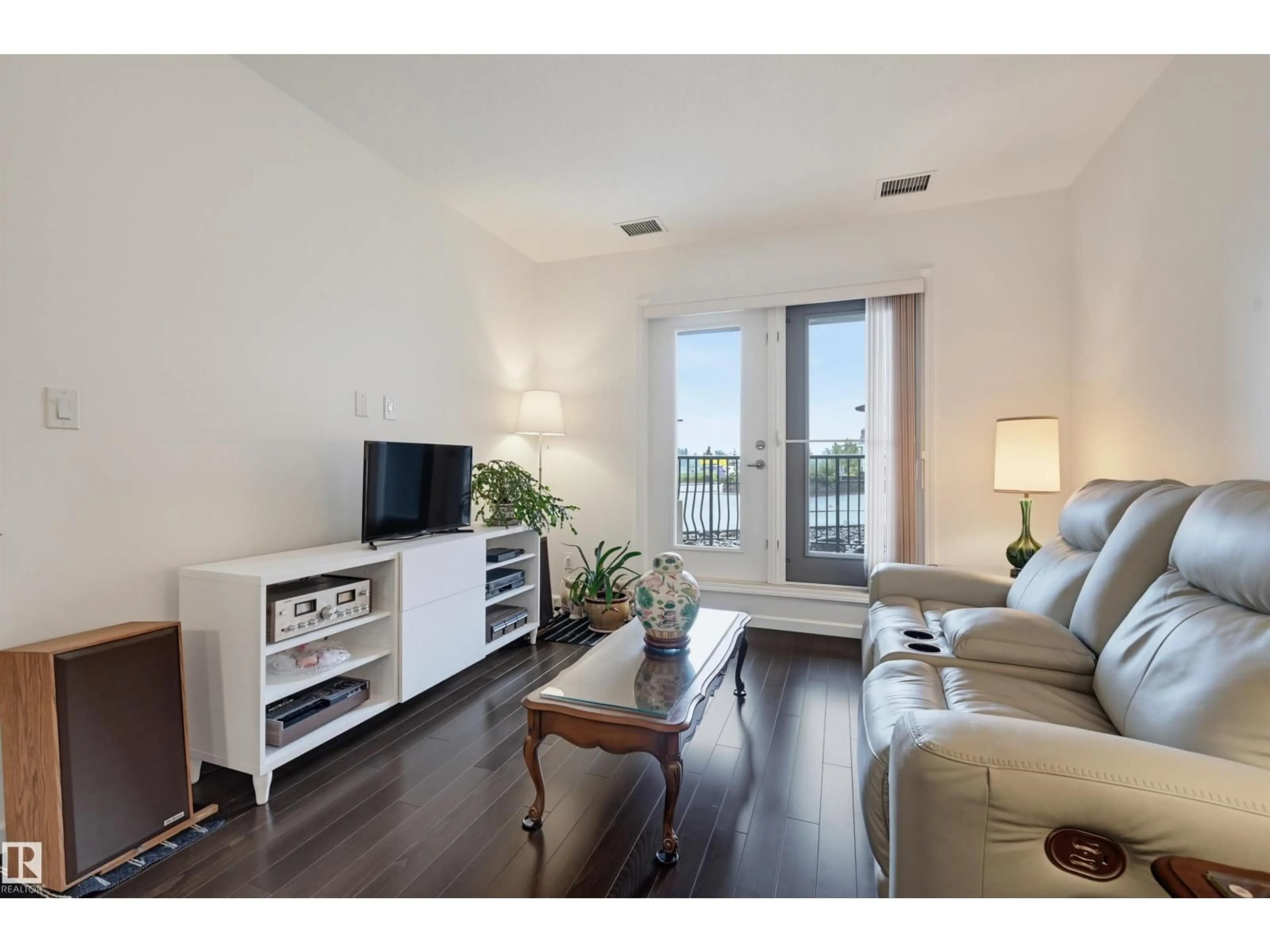 Living room with furniture, wood/laminate floor for 6083 - 110 MAYNARD WY, Edmonton Alberta T6R0S5