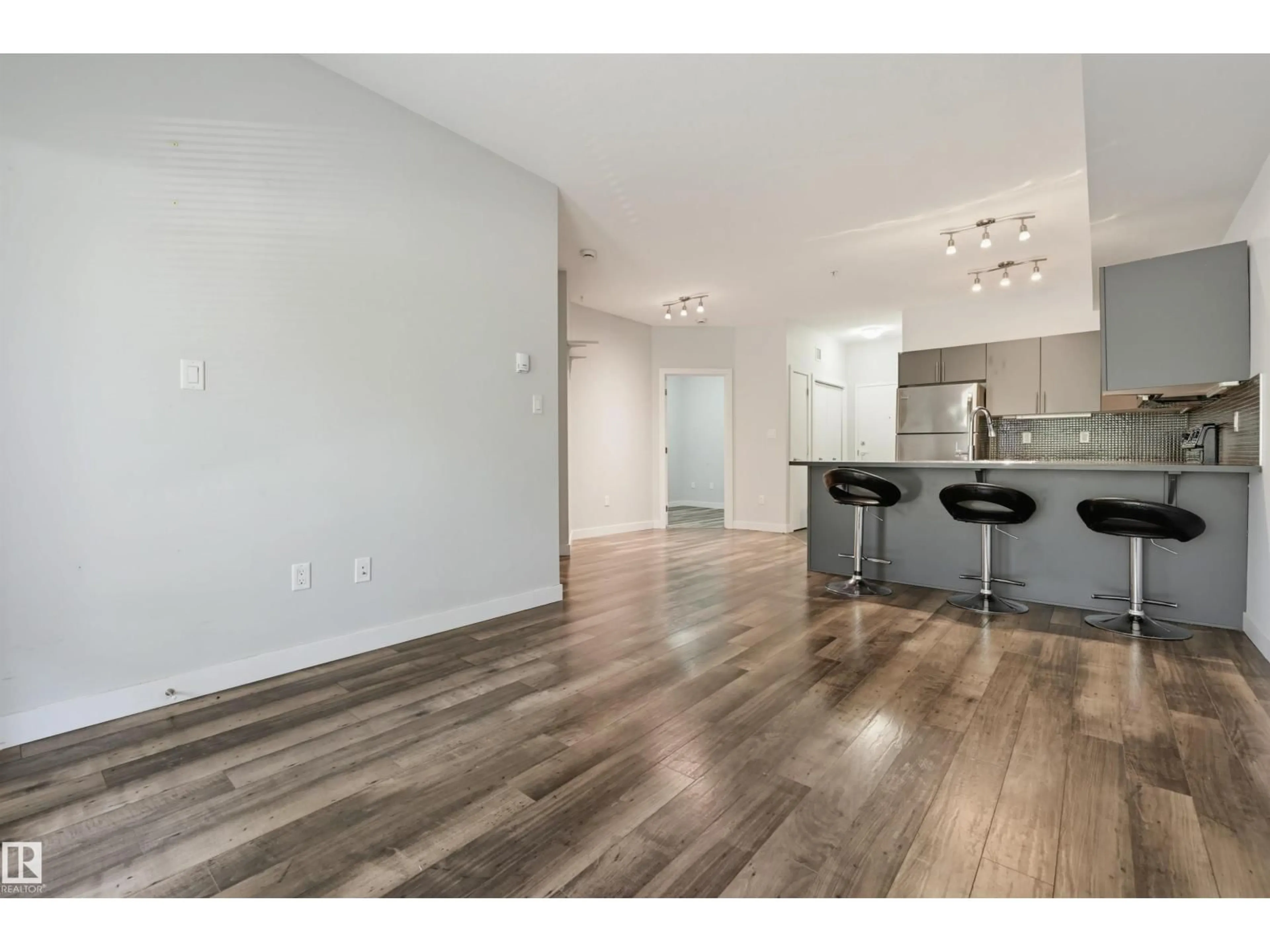 Open concept kitchen, wood/laminate floor for #103 - 10611 117 ST, Edmonton Alberta T5H0G6