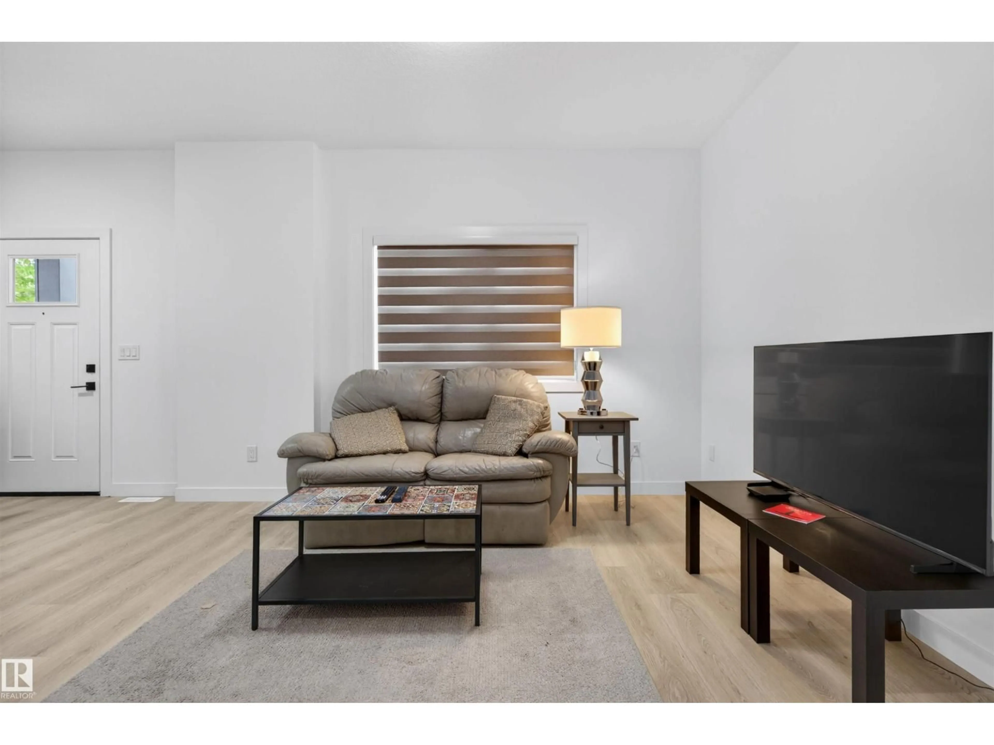 Living room with furniture, wood/laminate floor for NW - 10915 159 ST, Edmonton Alberta T5P3B9