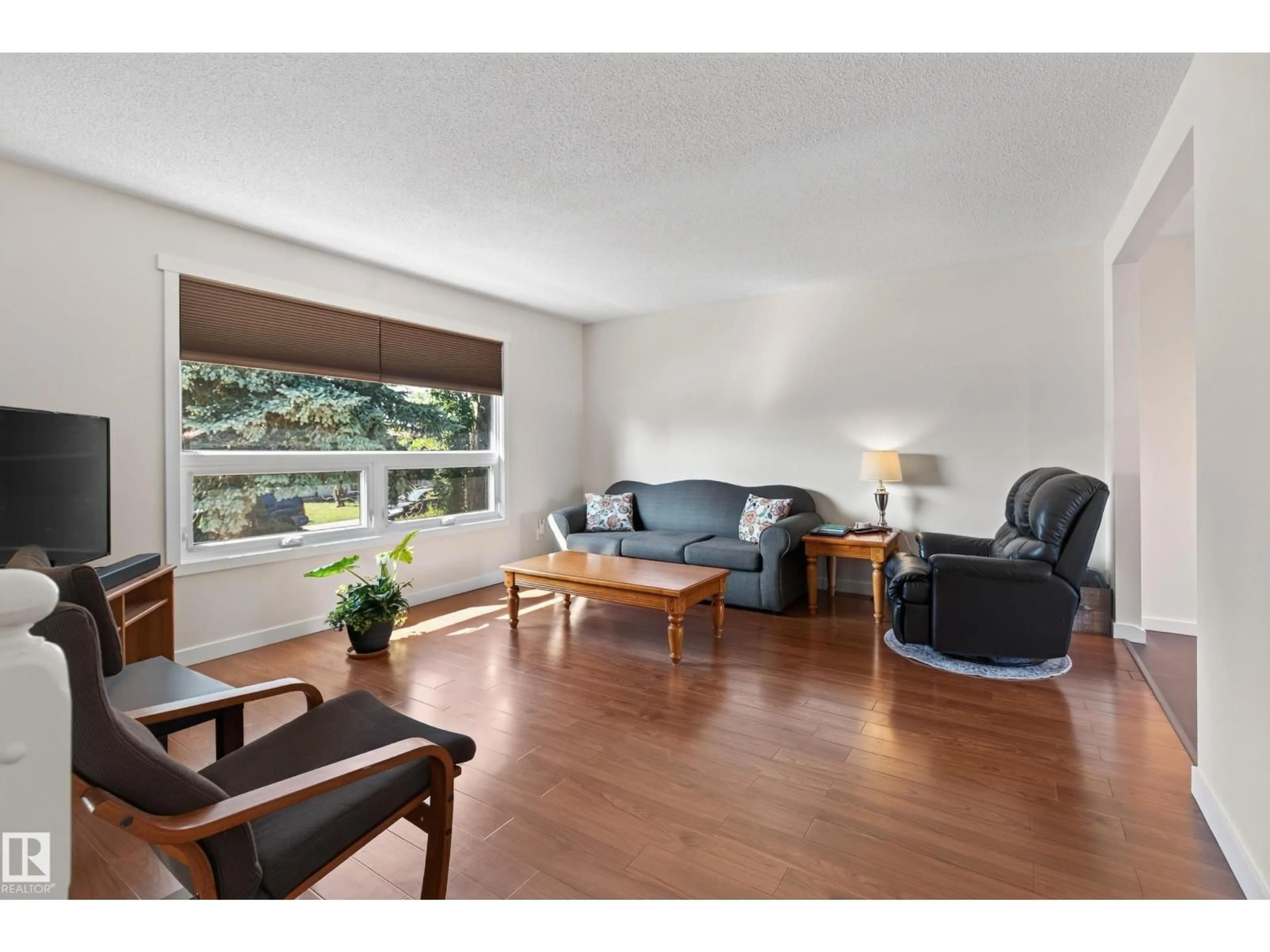 Living room with furniture, wood/laminate floor for NW - 16531 116 ST, Edmonton Alberta T5X4B2