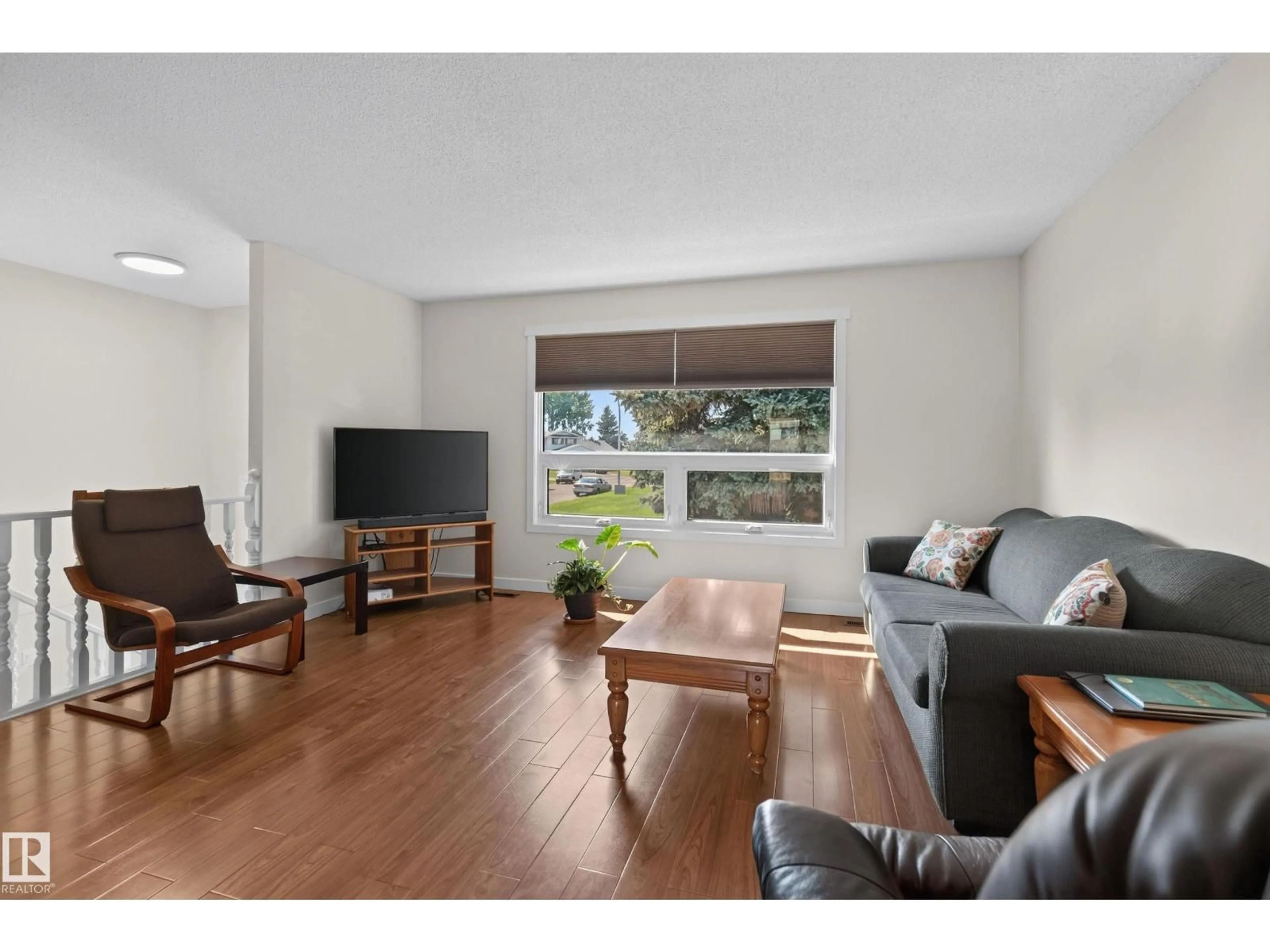 Living room with furniture, wood/laminate floor for NW - 16531 116 ST, Edmonton Alberta T5X4B2