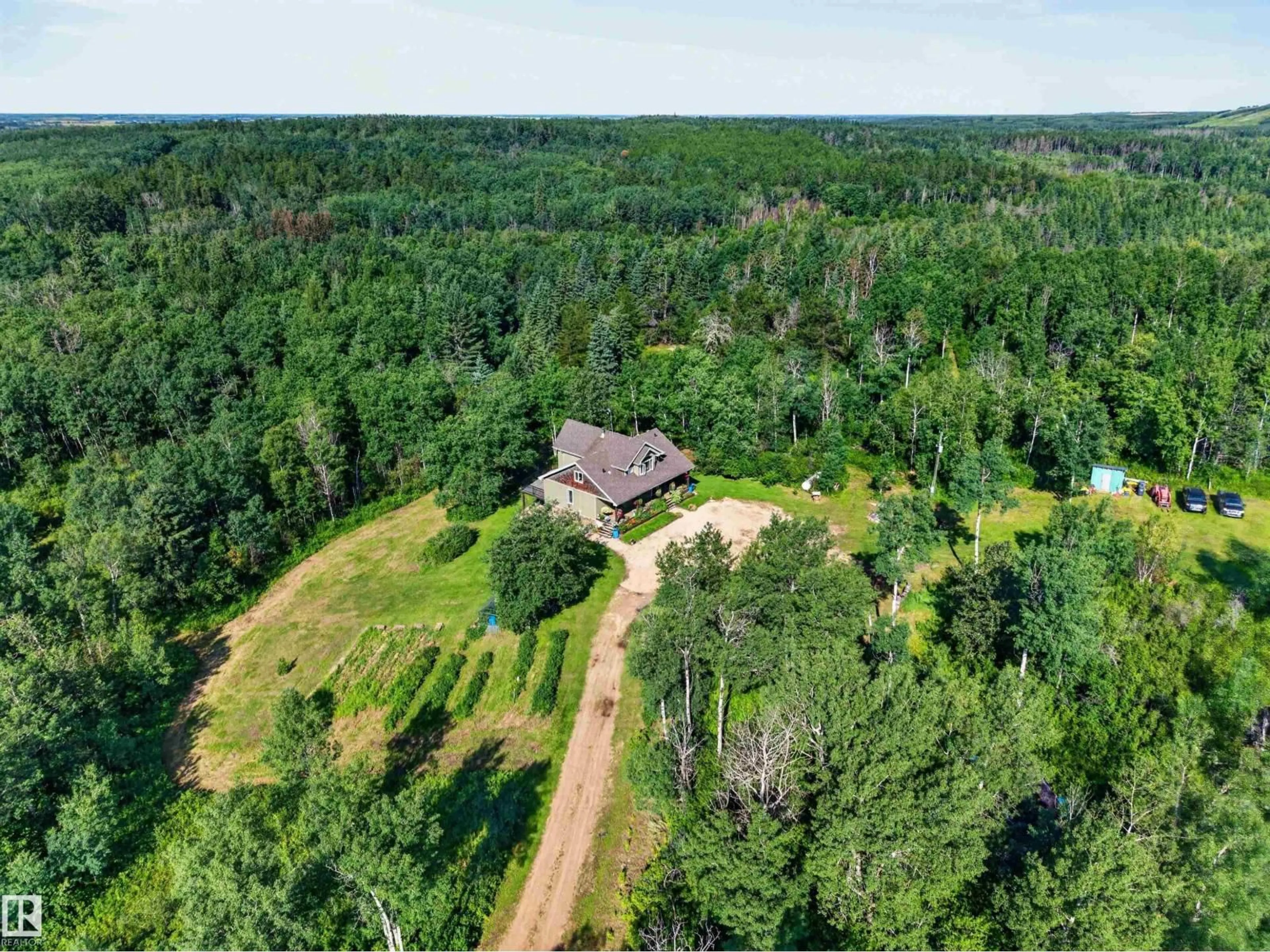 A pic from outside/outdoor area/front of a property/back of a property/a pic from drone, forest/trees view for 59122 RGE ROAD 233, Rural Westlock County Alberta T0G2J0