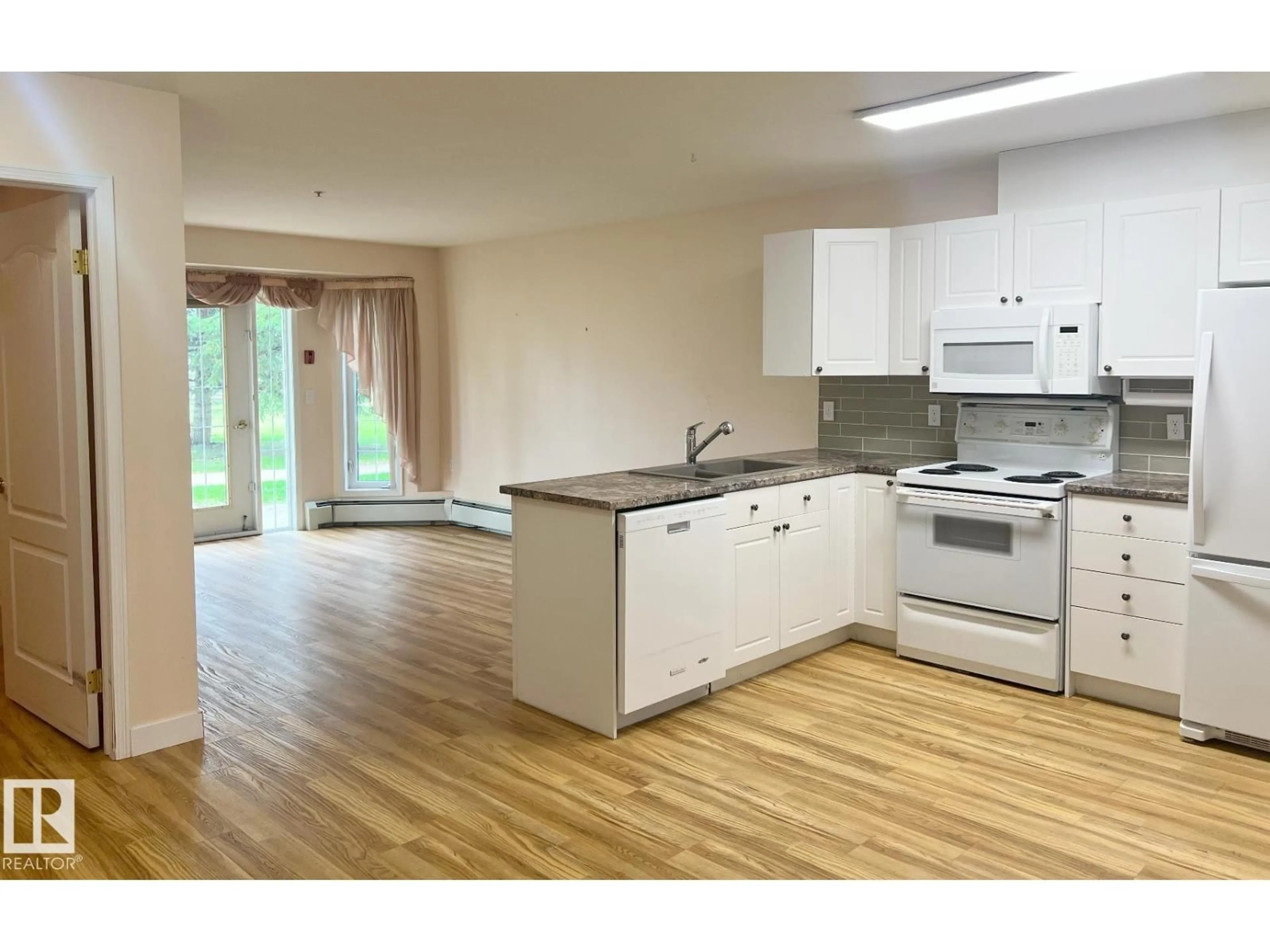 Open concept kitchen, wood/laminate floor for #147 - 13441 127 ST, Edmonton Alberta T5J6B6
