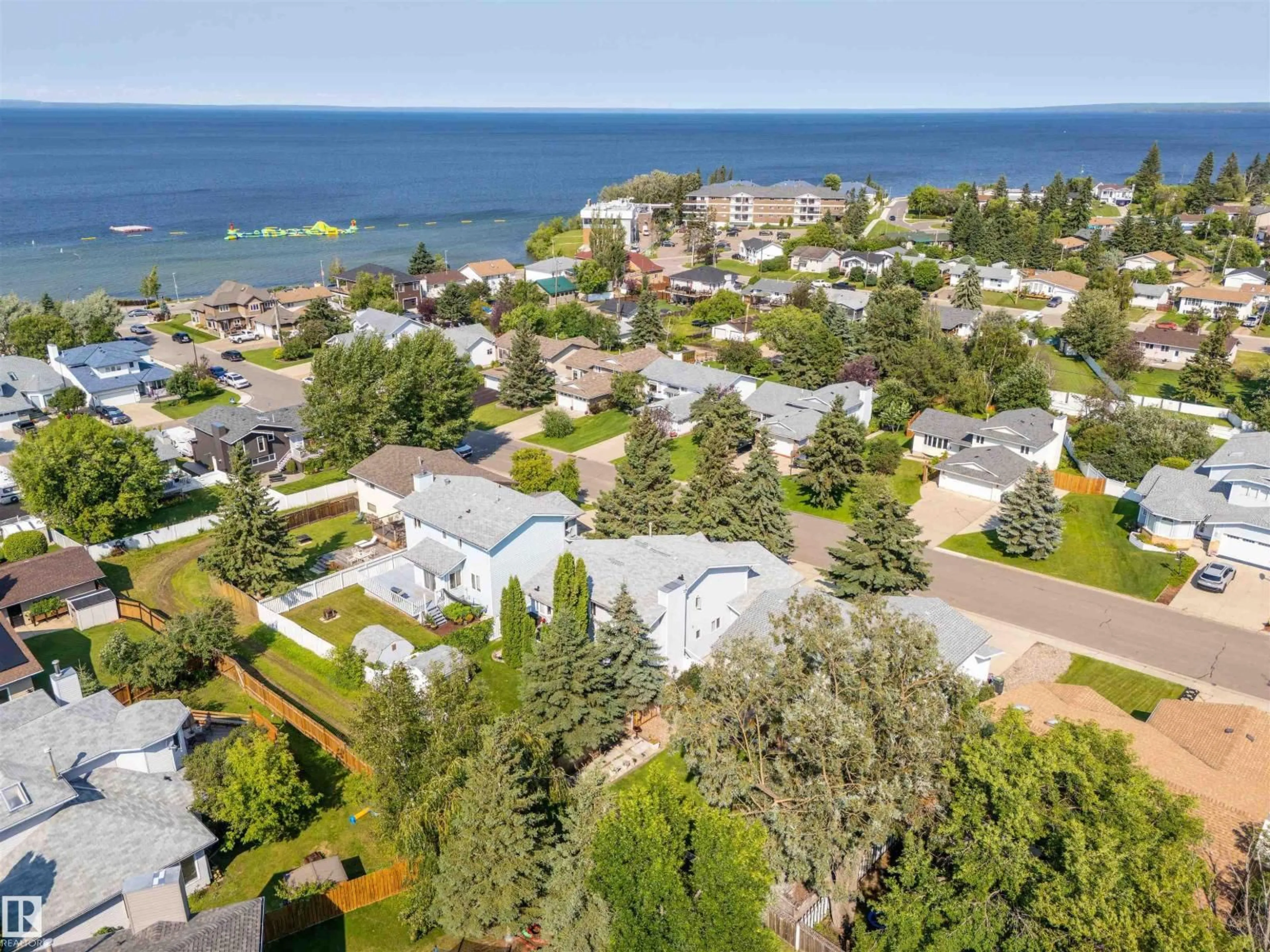 A pic from outside/outdoor area/front of a property/back of a property/a pic from drone, water/lake/river/ocean view for 207 18 ST, Cold Lake Alberta T9M1B5