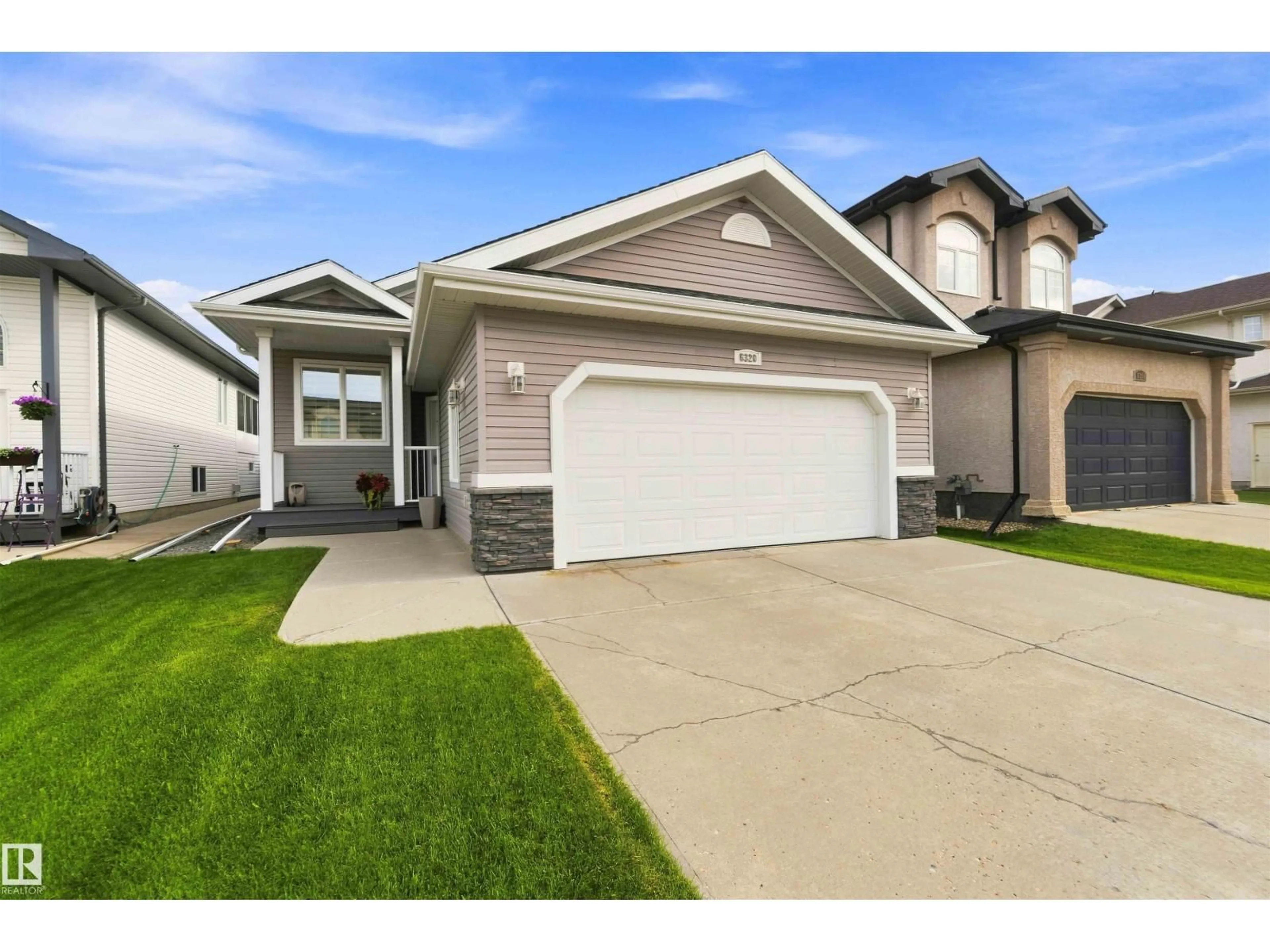 Home with vinyl exterior material, street for 6320 166 AV, Edmonton Alberta T5Y3M9