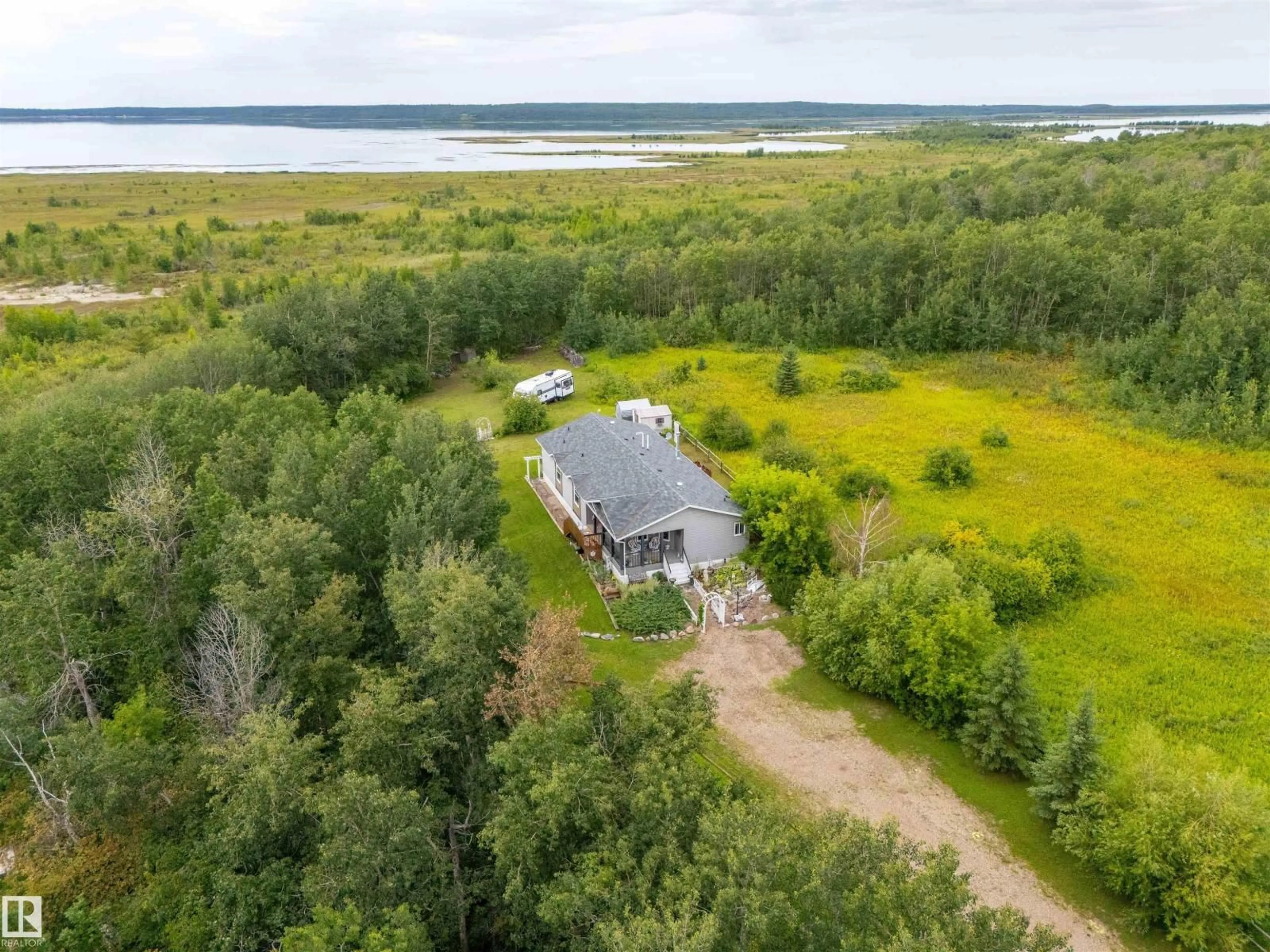 A pic from outside/outdoor area/front of a property/back of a property/a pic from drone, water/lake/river/ocean view for 59526 - 116 HWY 657, Rural Bonnyville M.D. Alberta T9N2G3