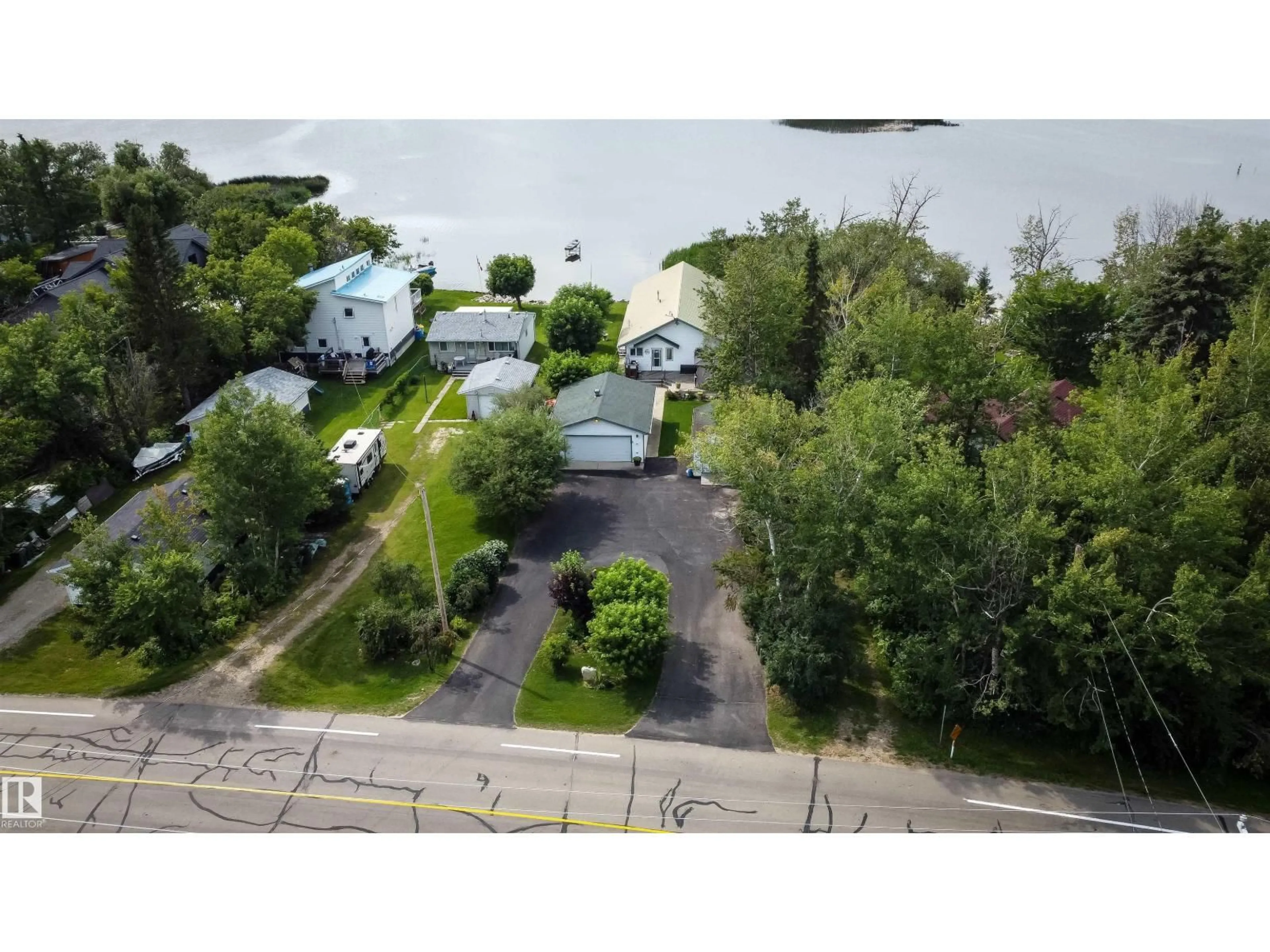 A pic from outside/outdoor area/front of a property/back of a property/a pic from drone, water/lake/river/ocean view for 4740 SUNSET DR, Rural Lac Ste. Anne County Alberta T0E0A0