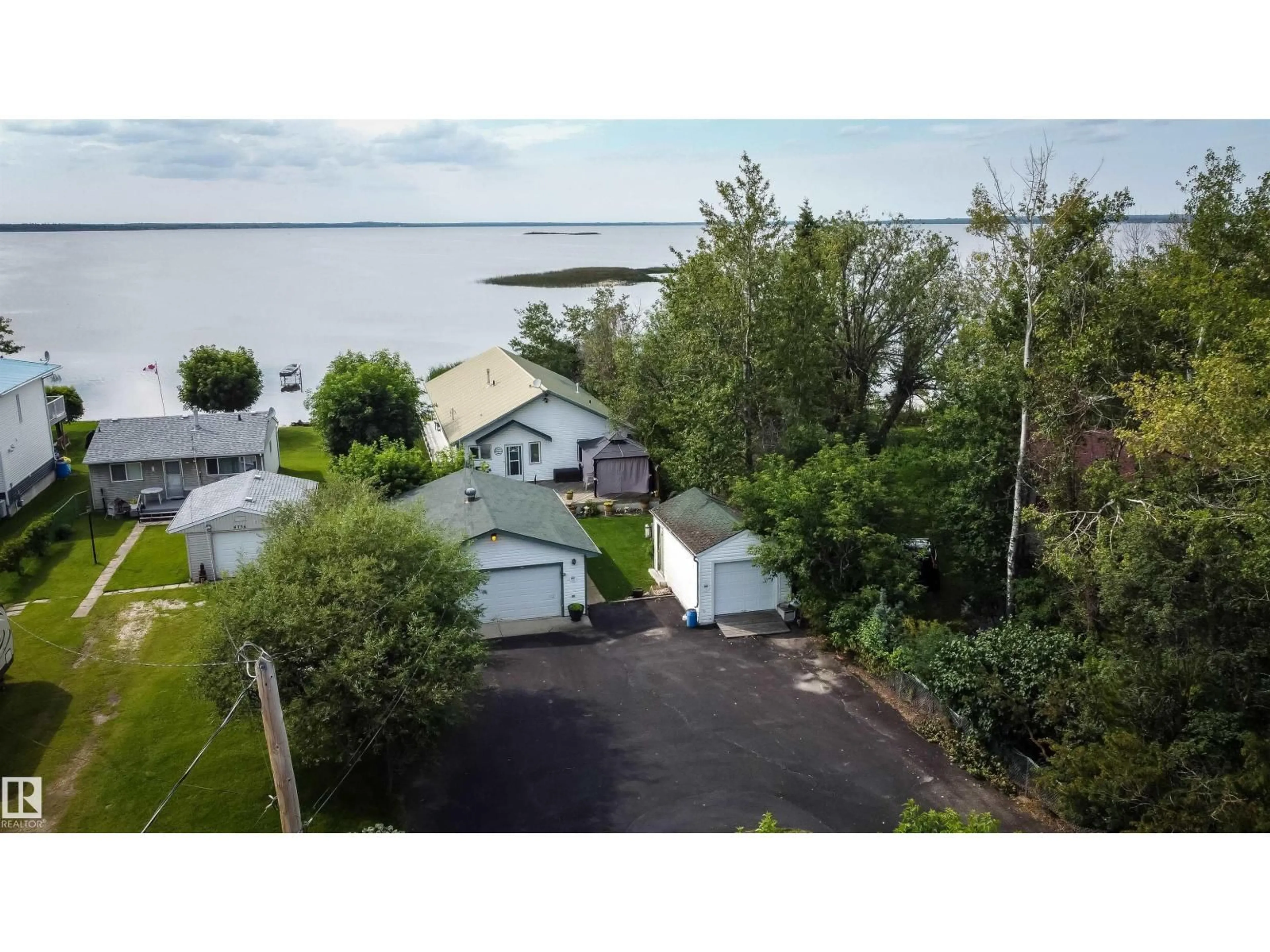 A pic from outside/outdoor area/front of a property/back of a property/a pic from drone, water/lake/river/ocean view for 4740 SUNSET DR, Rural Lac Ste. Anne County Alberta T0E0A0