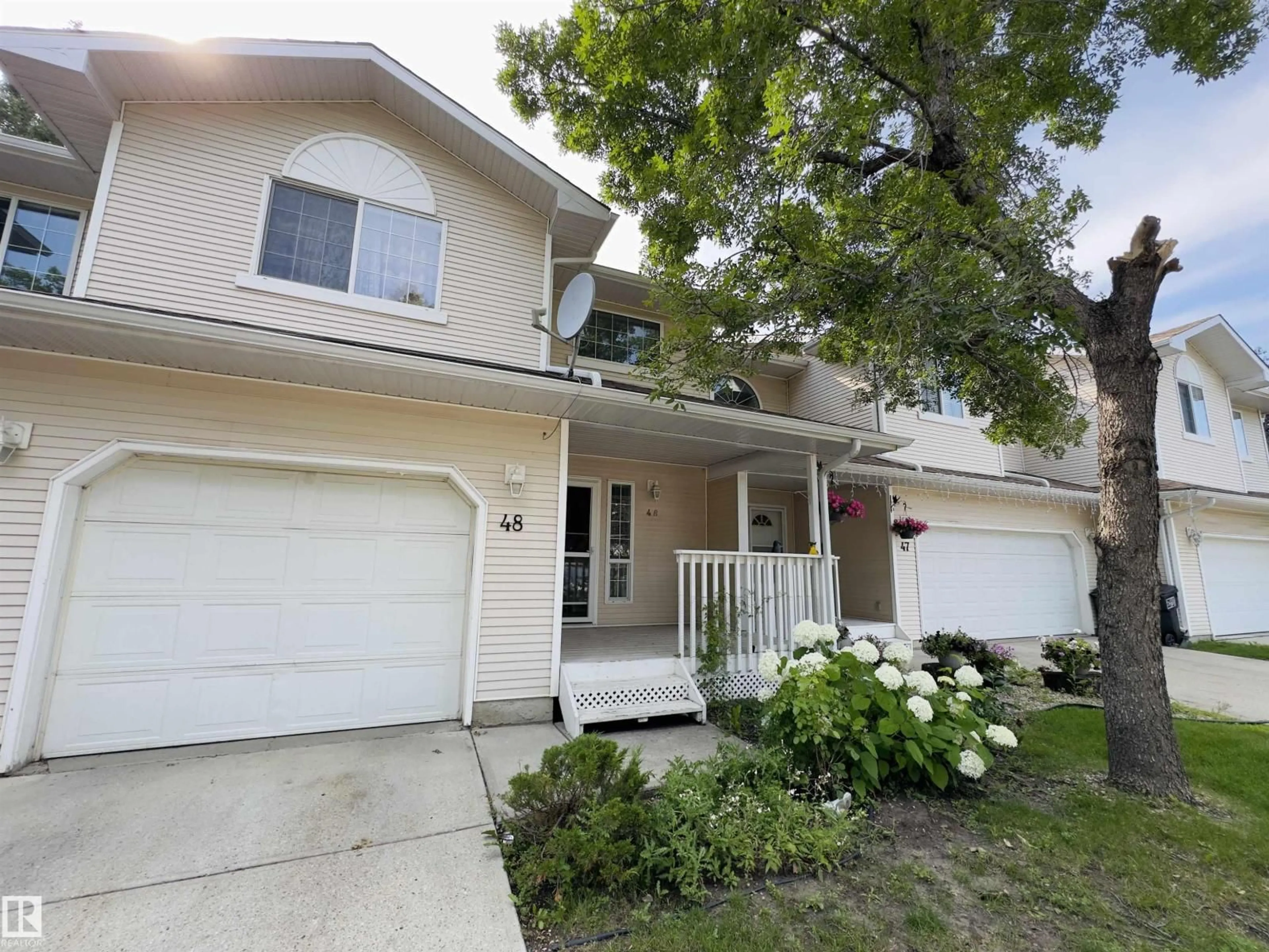 Home with vinyl exterior material, street for #48 - 6608 158 AV, Edmonton Alberta T5Z3H2