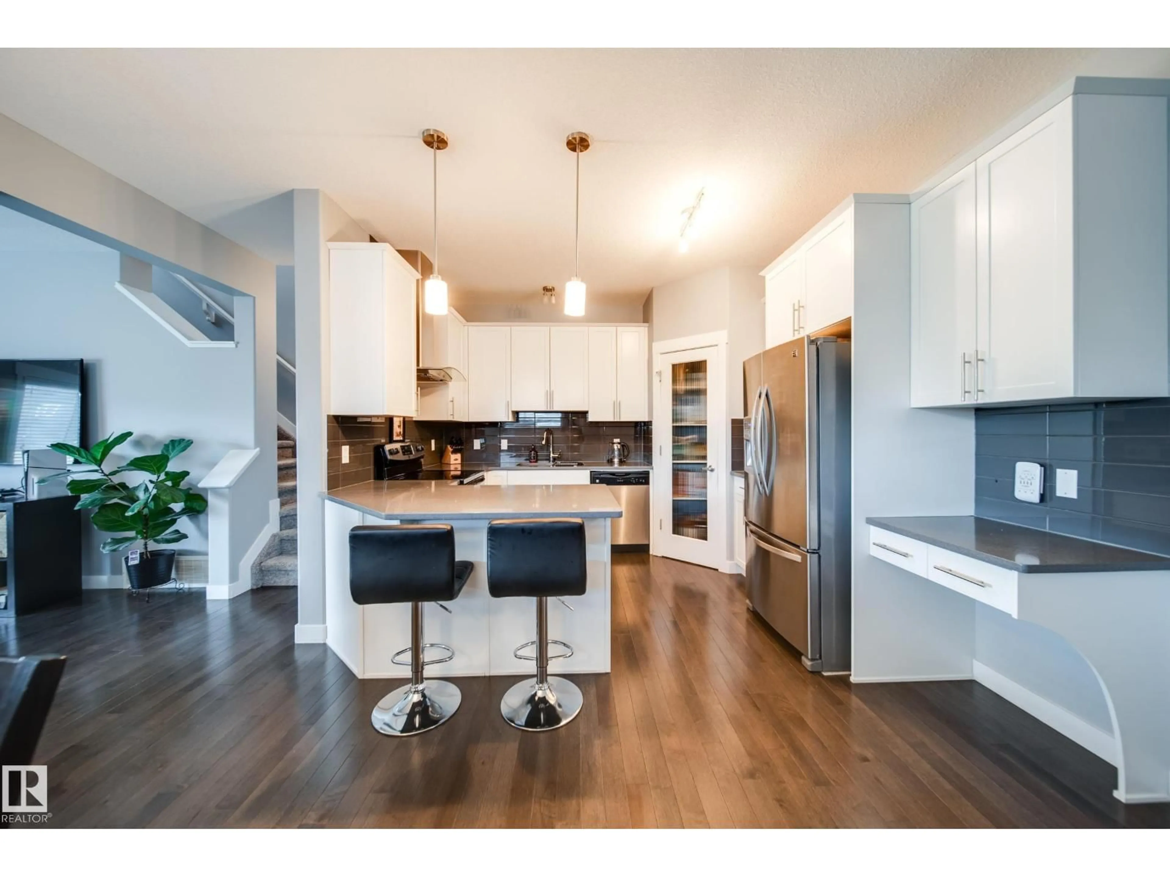 Open concept kitchen, wood/laminate floor for 6305 167A AV, Edmonton Alberta T5Y3P7