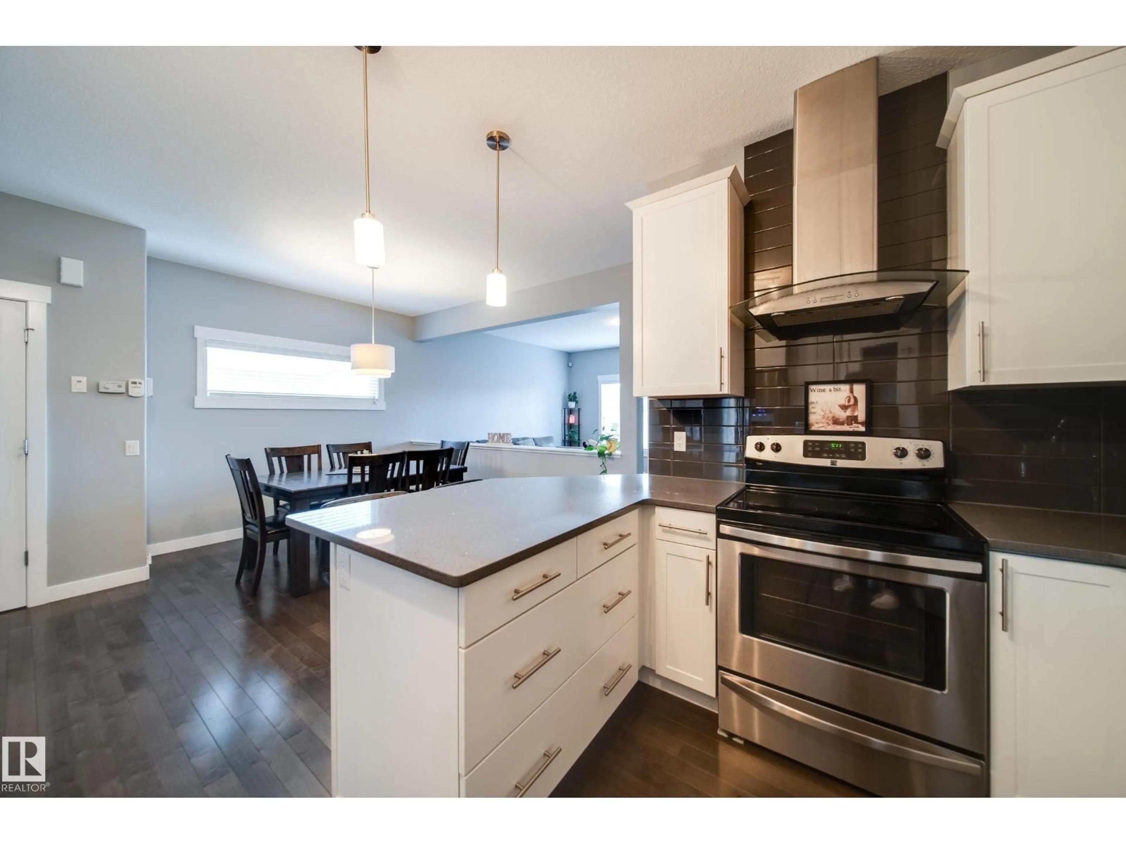Open concept kitchen, wood/laminate floor for 6305 167A AV, Edmonton Alberta T5Y3P7