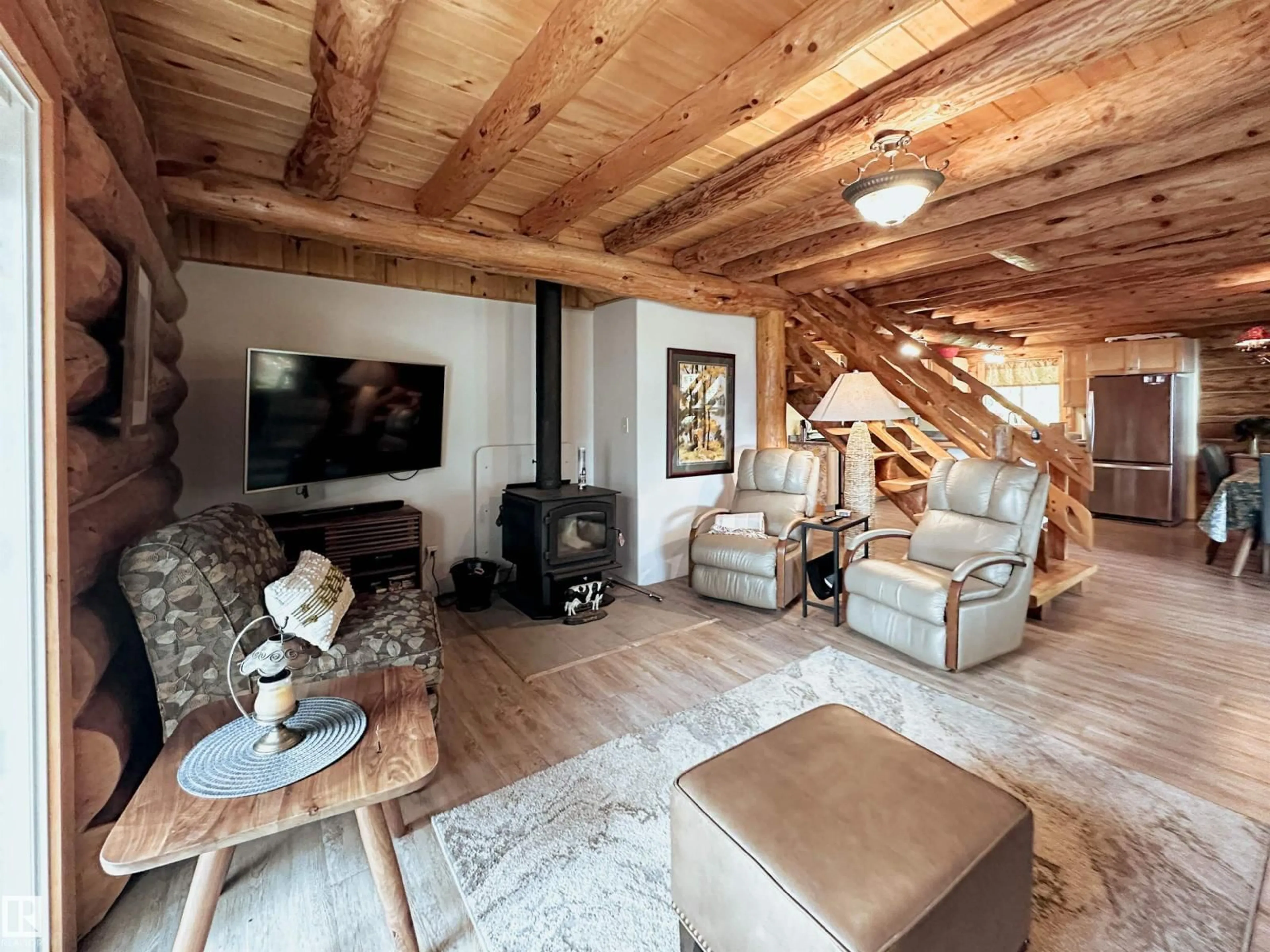 Living room with furniture, wood/laminate floor for 9000 1 AV, Rural Parkland County Alberta T0E2B0