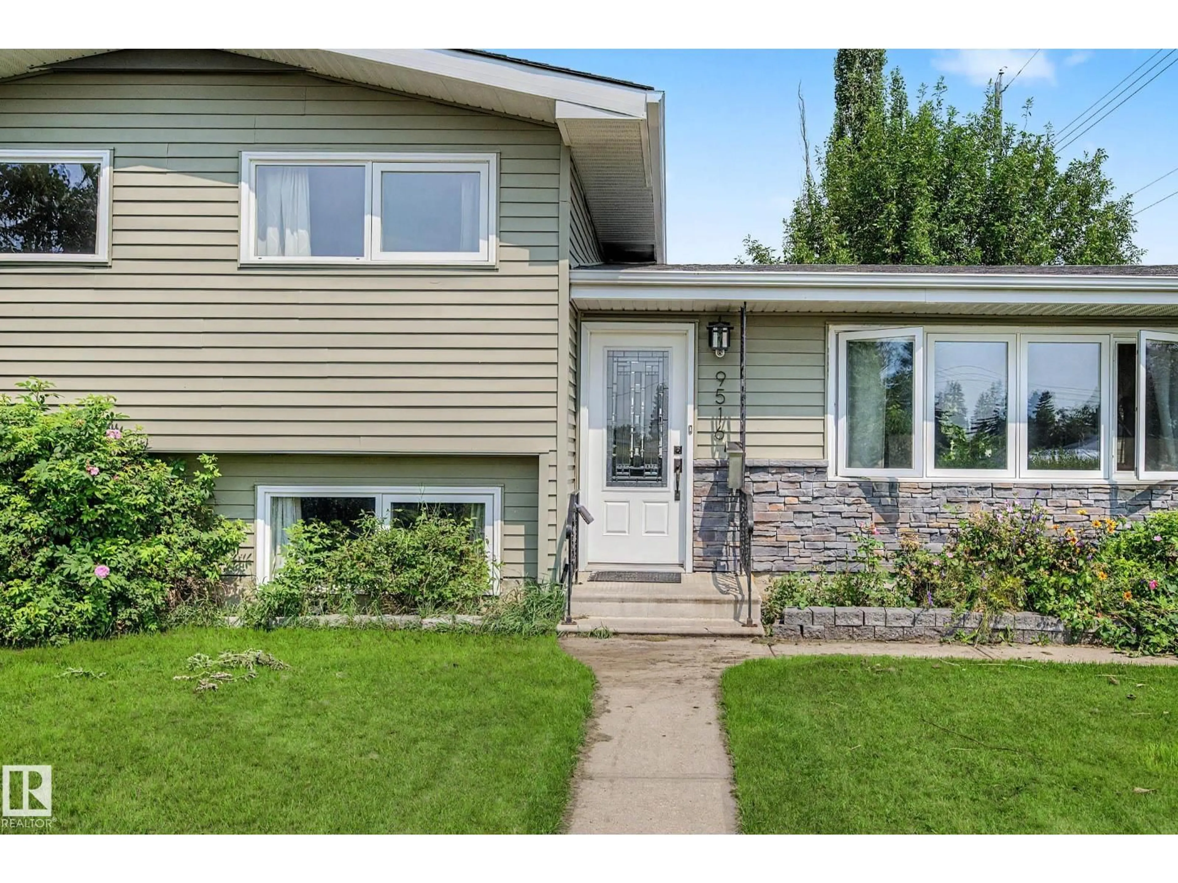 Home with vinyl exterior material, street for 9516 129A AV NW, Edmonton Alberta T5E0N8